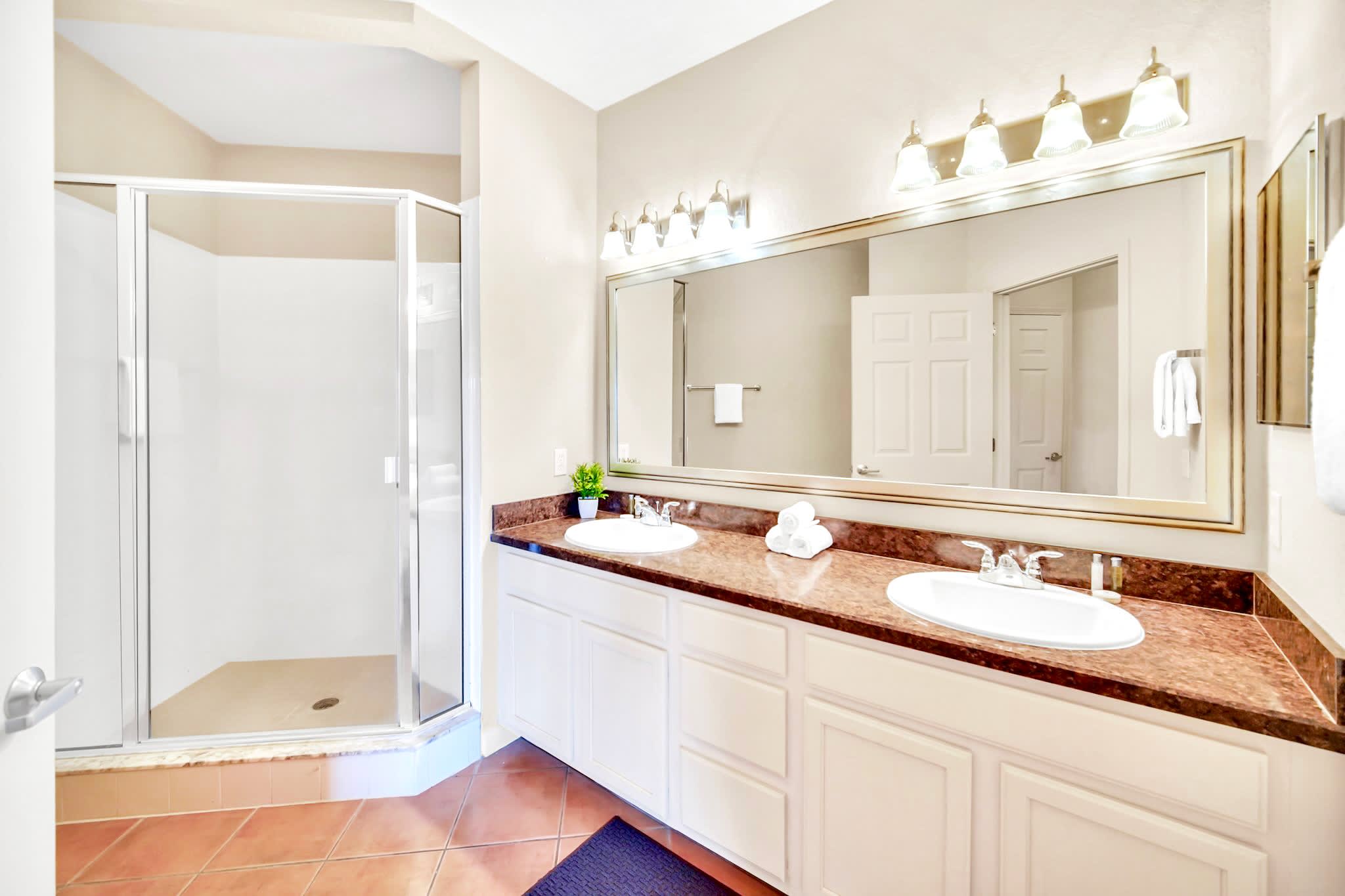 Spacious en-suite bathroom with double vanity and standing shower
