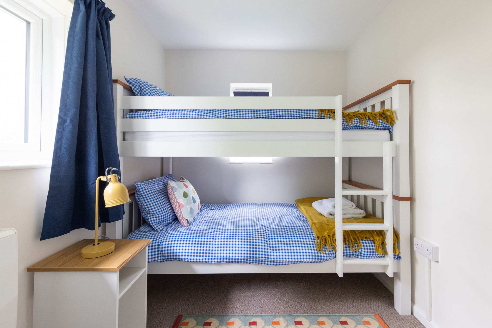 Single bunk beds with blue gingham linen!