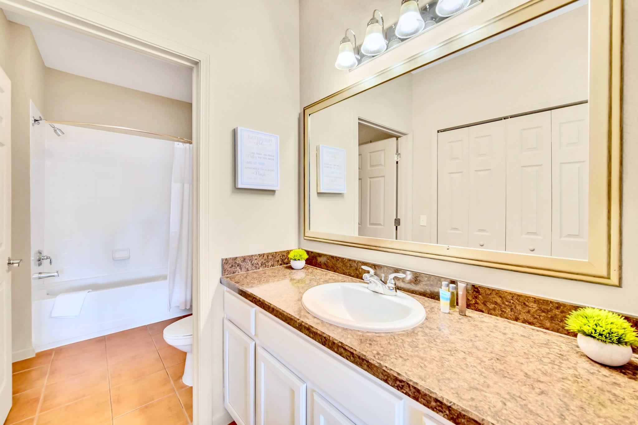 Full en-suite bathroom with combined shower and bathtub