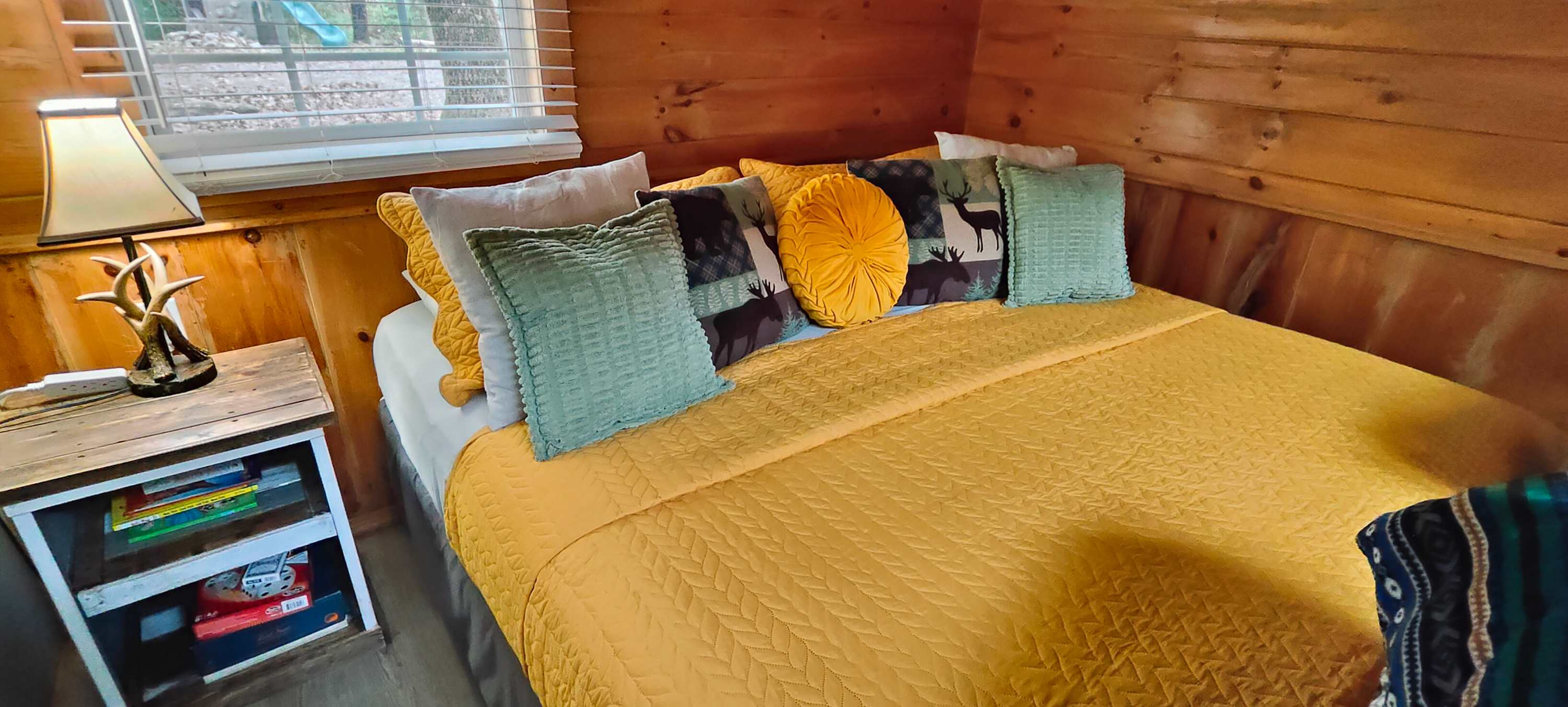 What a cozy king size bed!  This log cabin is private and ready for families.