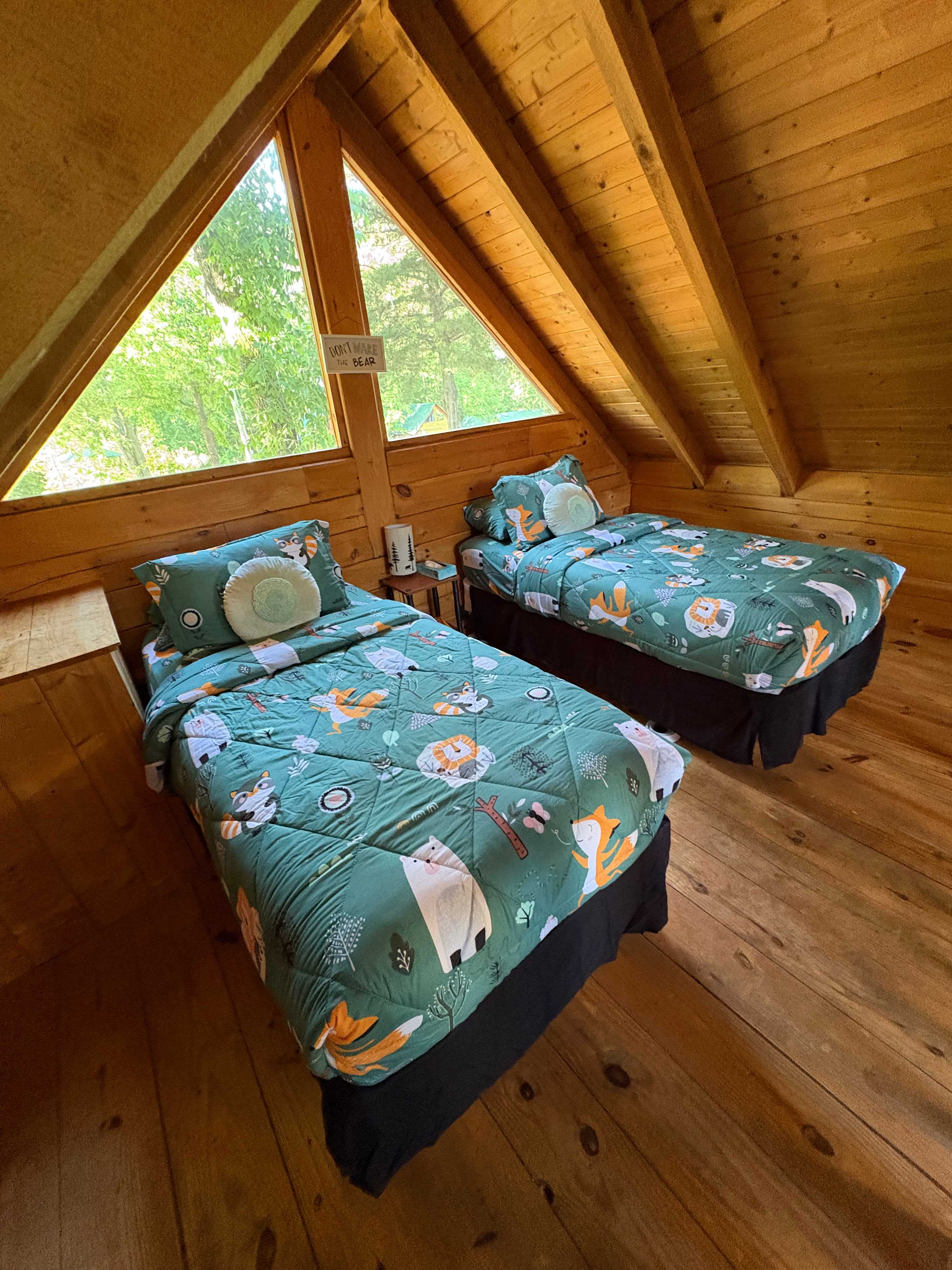 Kids love this bright and cozy loft! Two comfy twin beds and a fun view of the cabin’s surroundings make it a great space for rest or play.