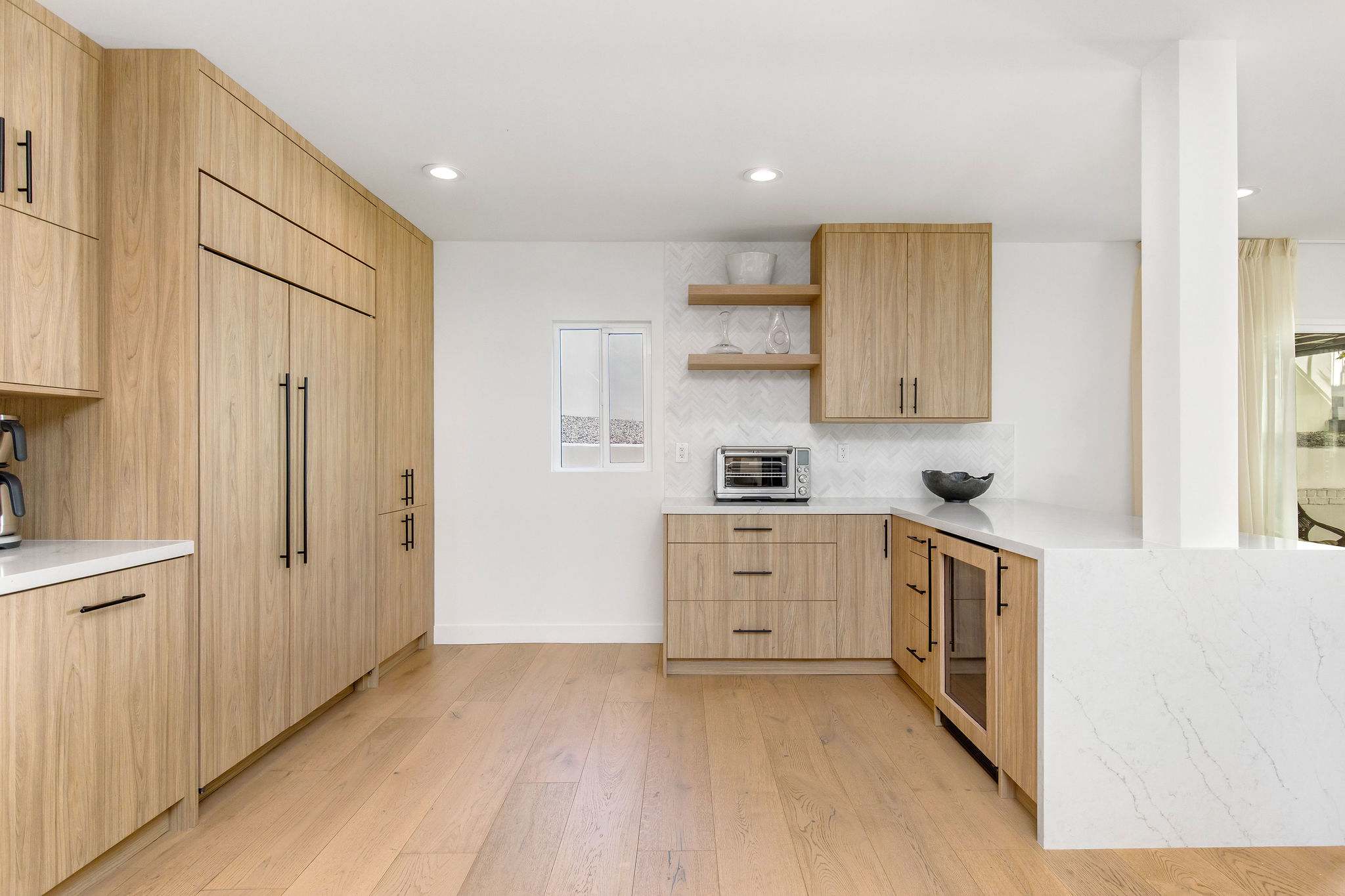 Let the chevron tile and custom oak cabinetry elevate every moment