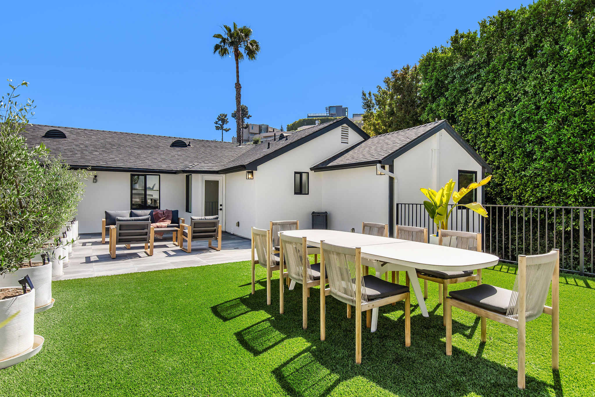 Alfresco dining on the lawn, framed by palms and privacy