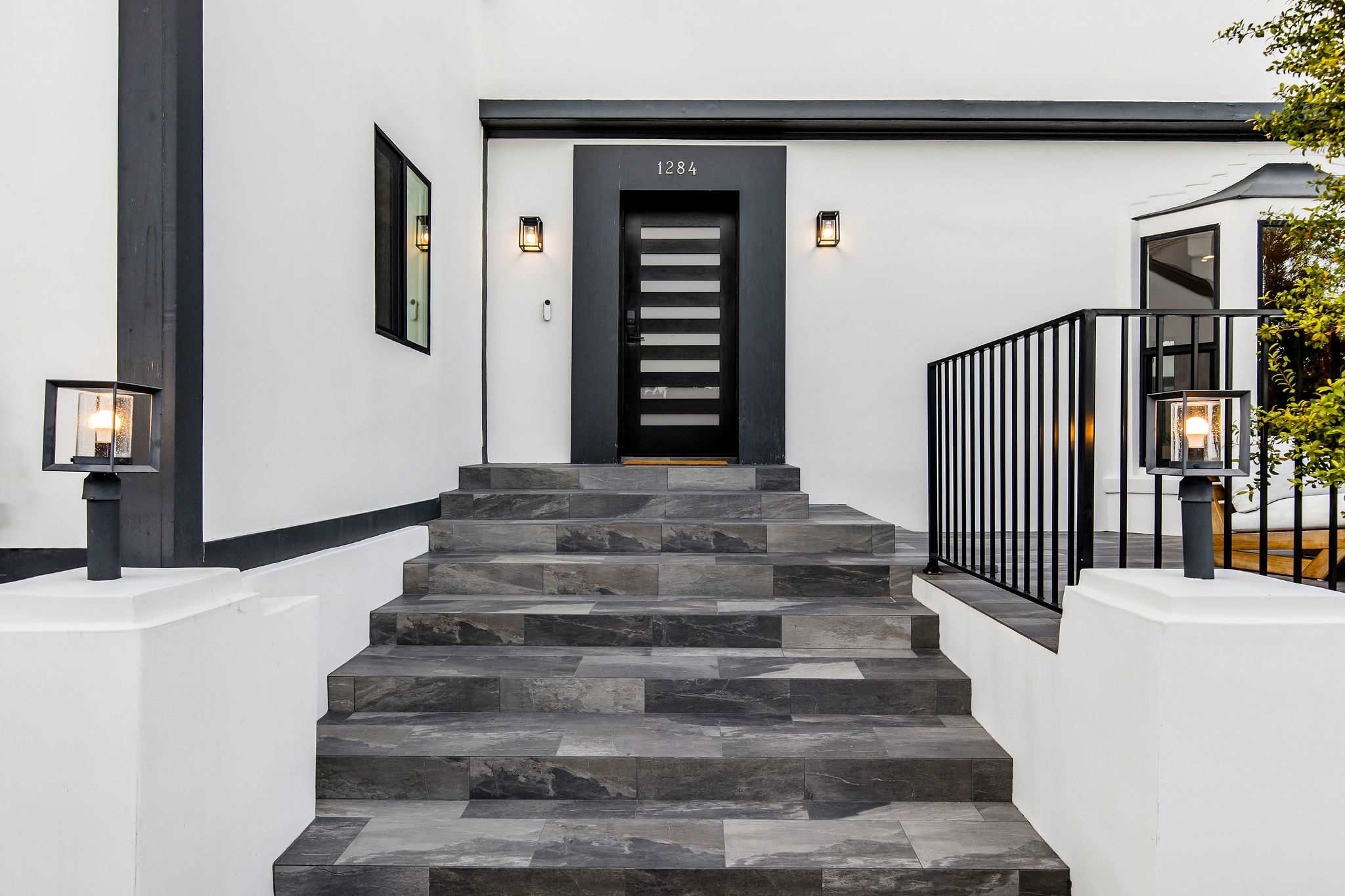 Enter through a private front with architectural lighting and striking contrasts.