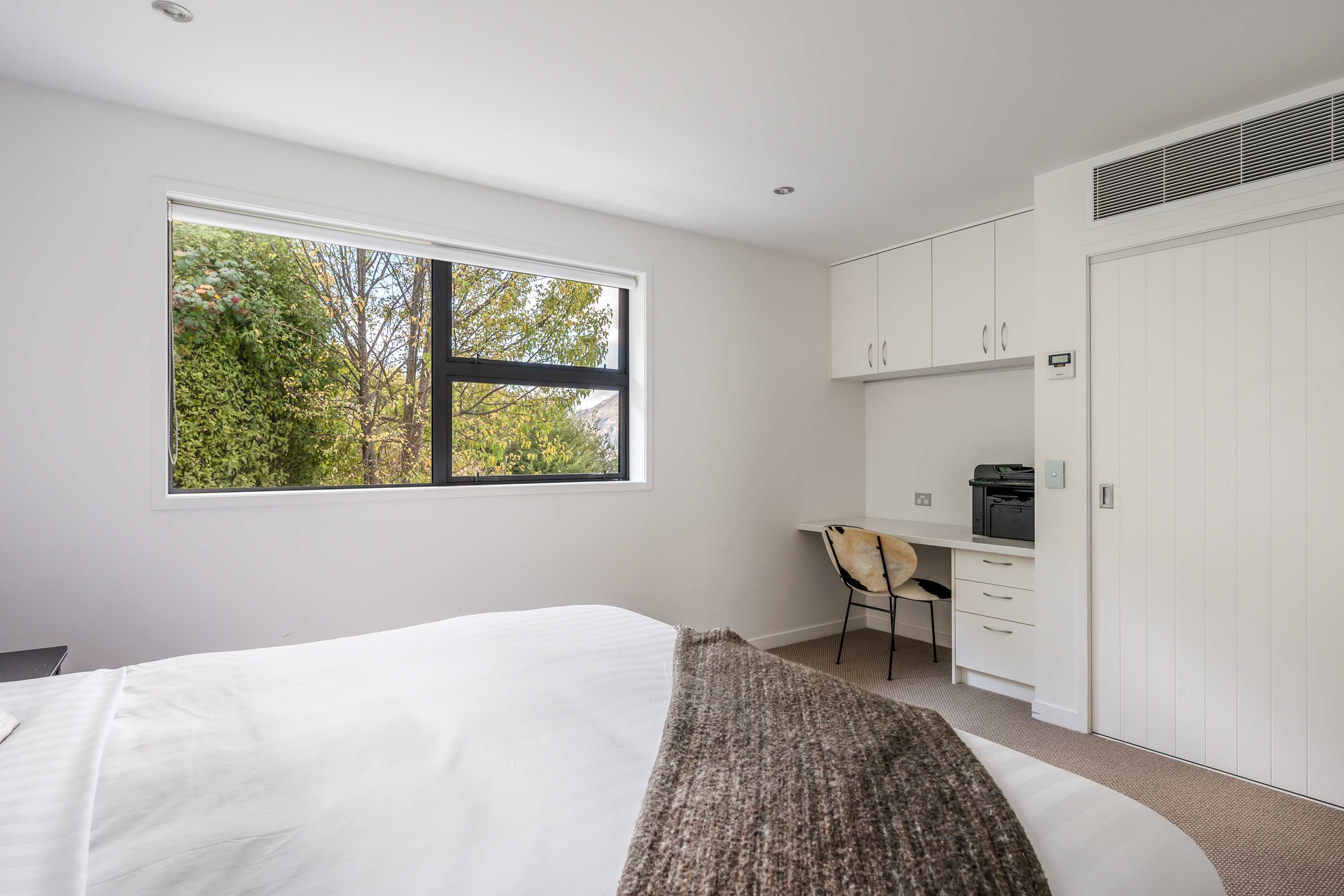 Stylish Second Bedroom with Work Station – This beautifully appointed second bedroom combines comfort and functionality, featuring plush bedding and a dedicated desk/work station, perfect for relaxing or getting some work done.