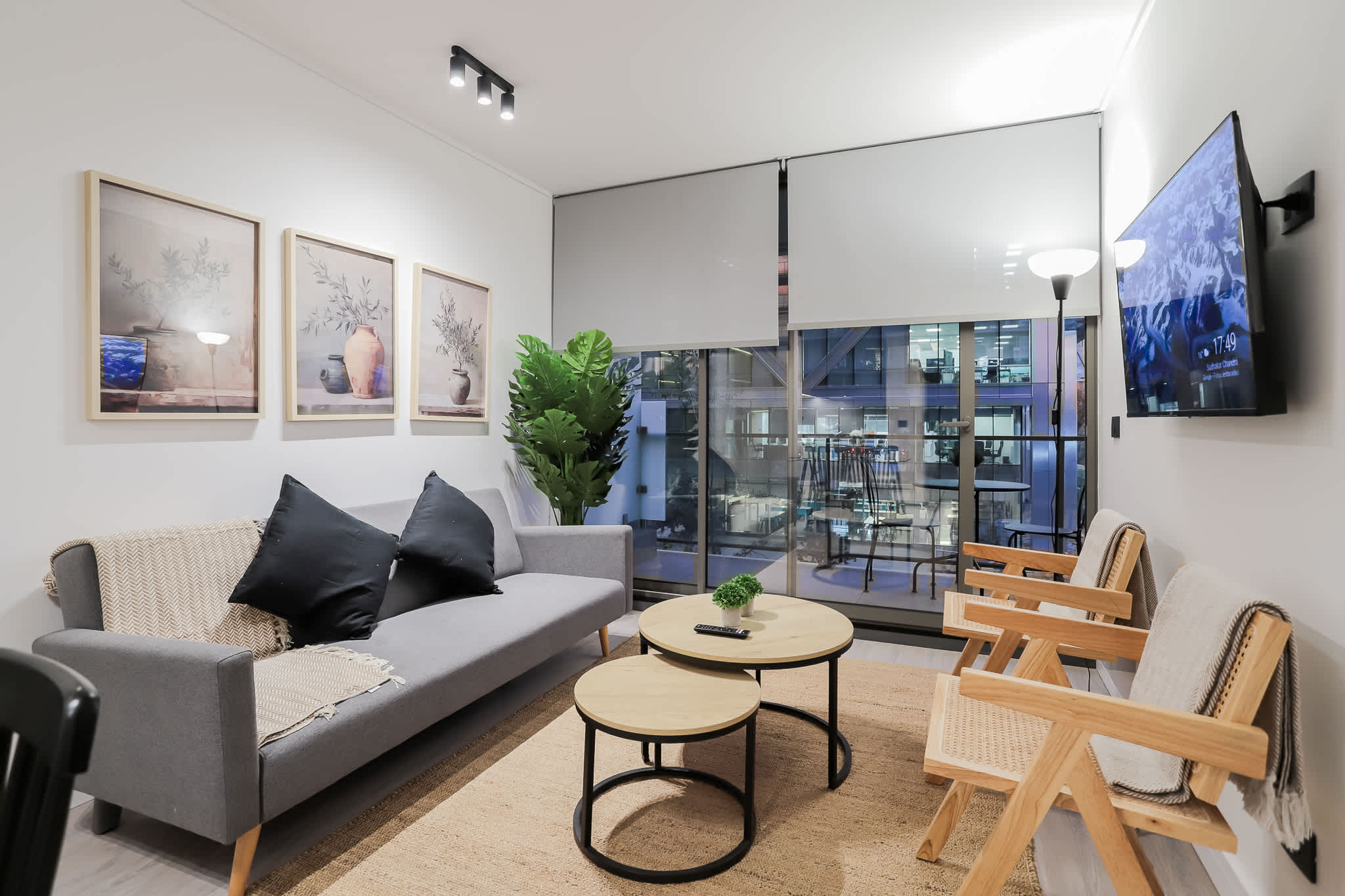 Relax in this stylish living room with city views, cozy seating, and modern decor—perfect for unwinding after a day of exploring.