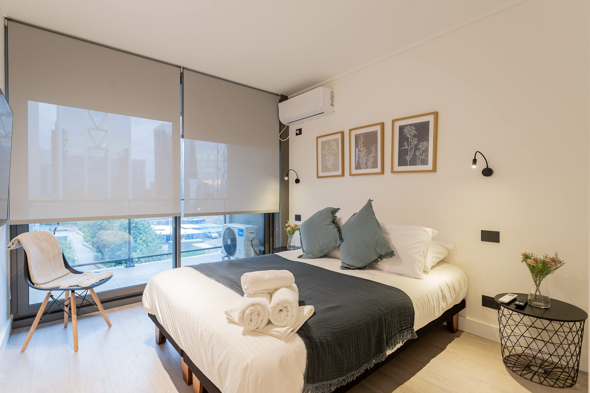 Relax in this cozy bedroom with city views, modern decor, and all the comforts you need for a restful stay.