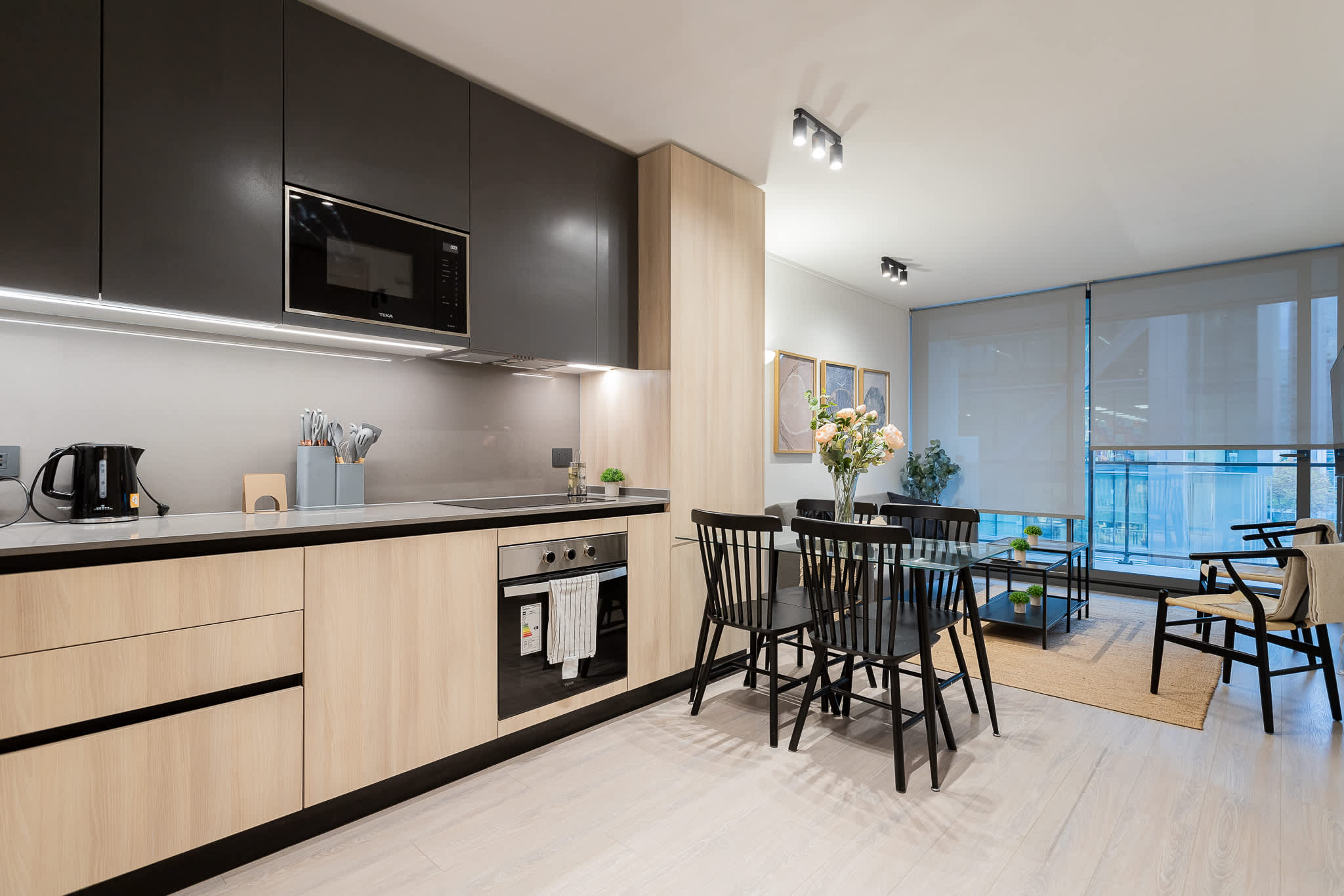 Experience modern elegance in this sleek kitchen and dining area, perfect for culinary adventures and cozy gatherings.