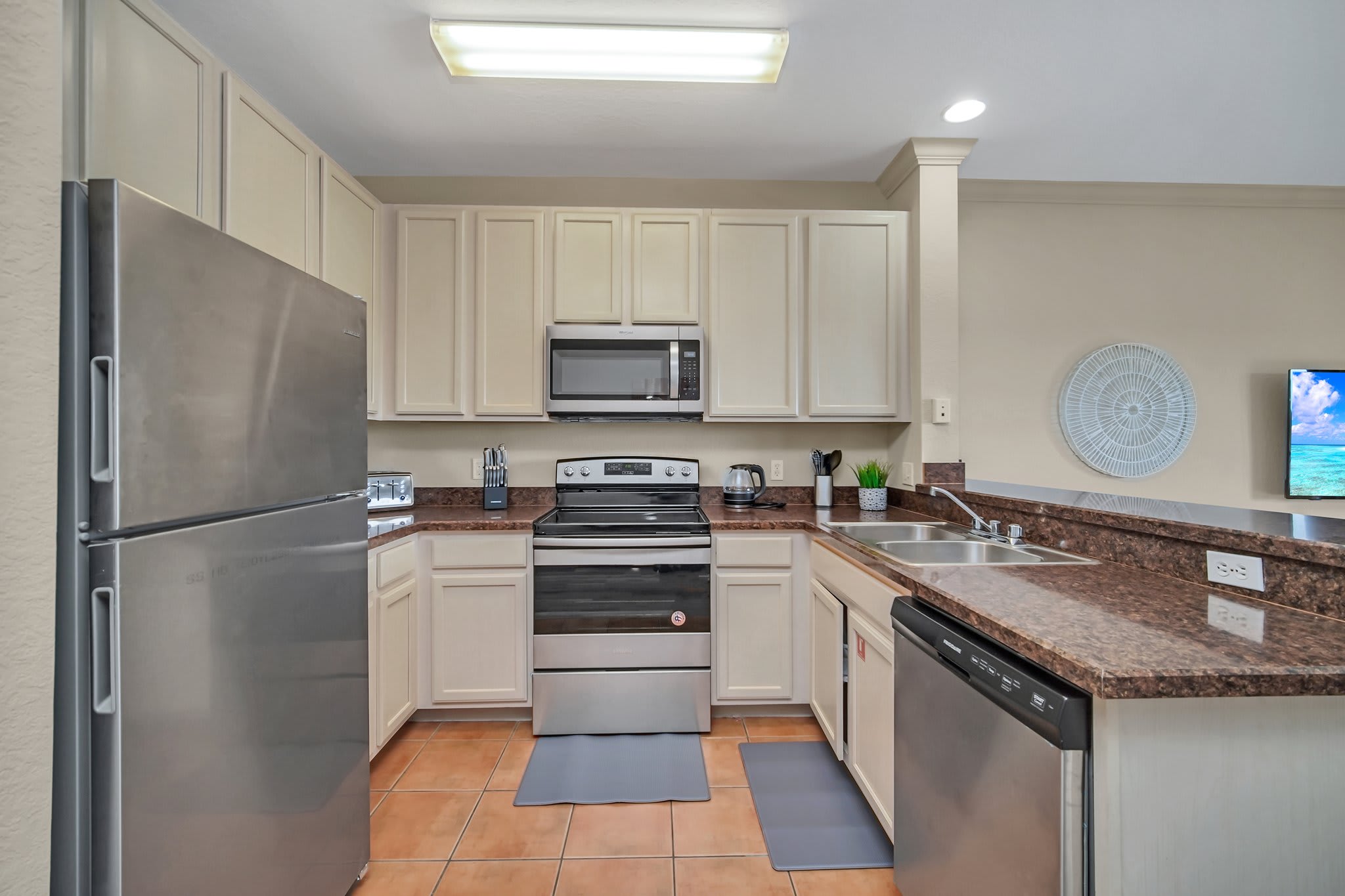 Fully equipped kitchen with silver appliances