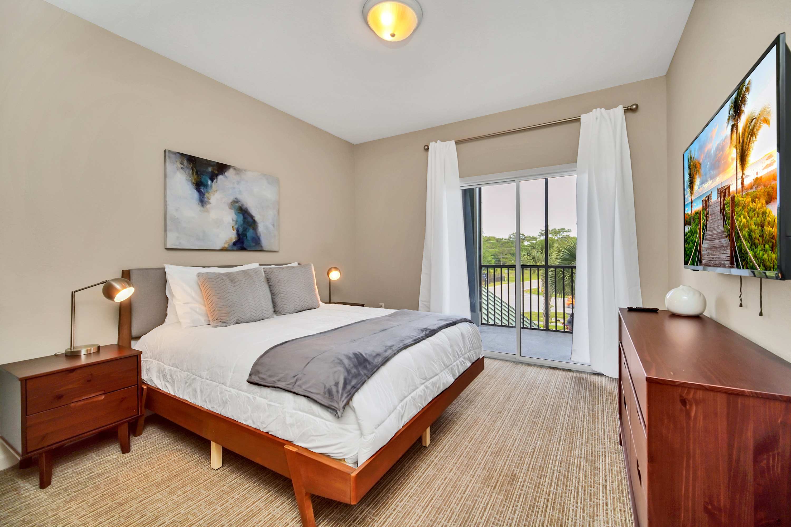 Queen bedroom with stylish decor and smart TV