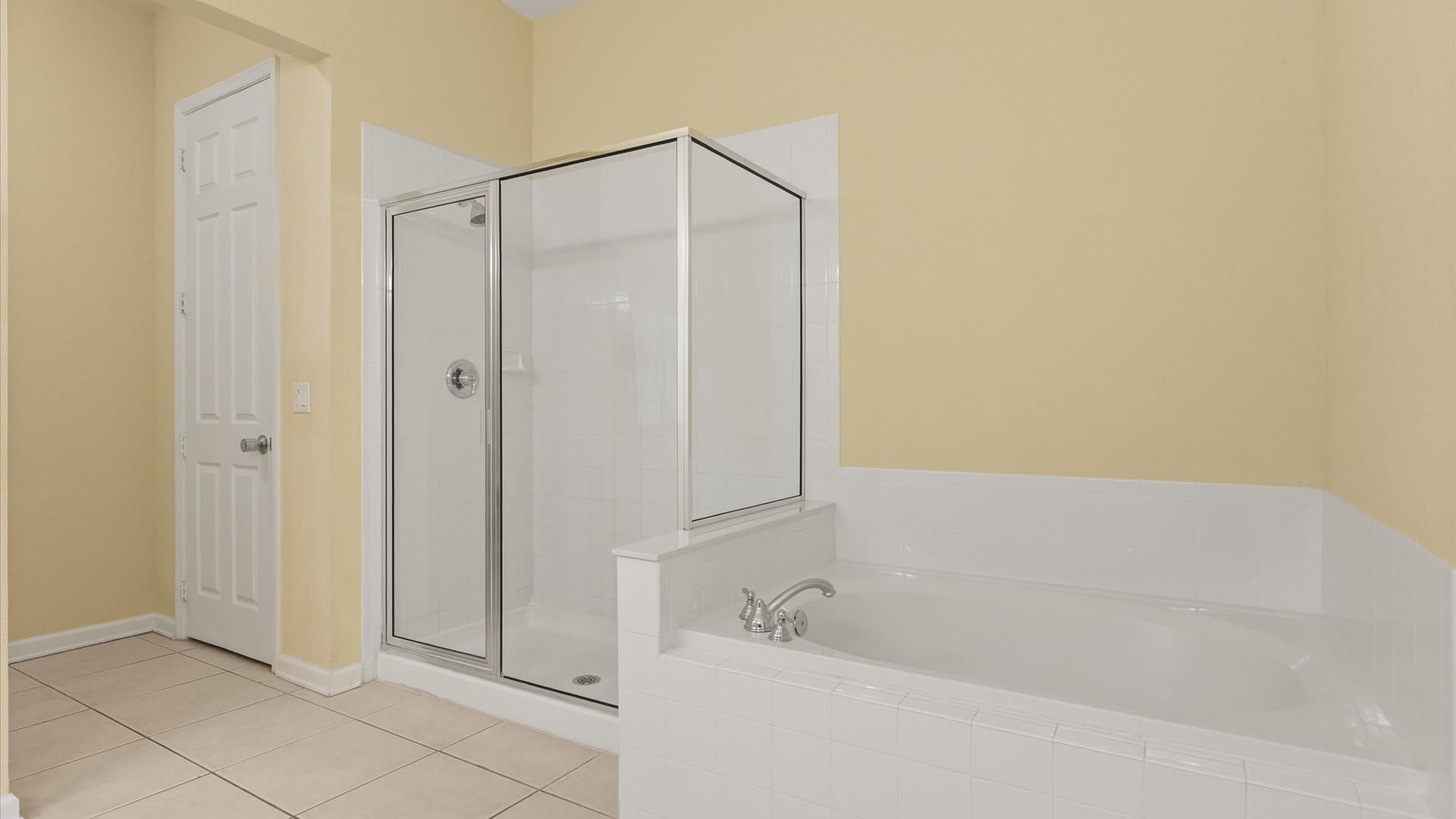En-suite bathroom with standing shower and bathtub