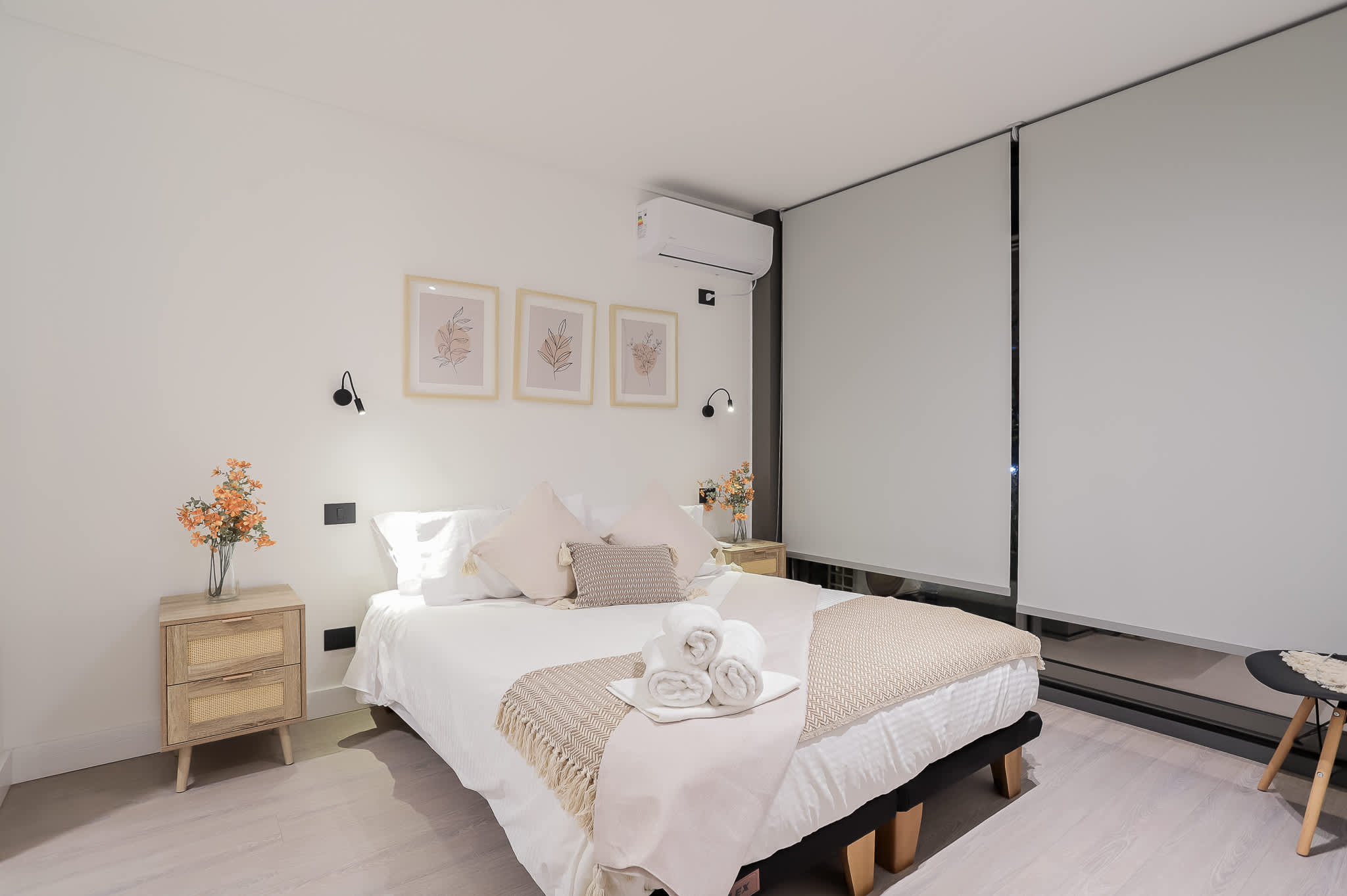 Relax in this serene bedroom with cozy bedding, stylish decor, and modern amenities for a restful stay.