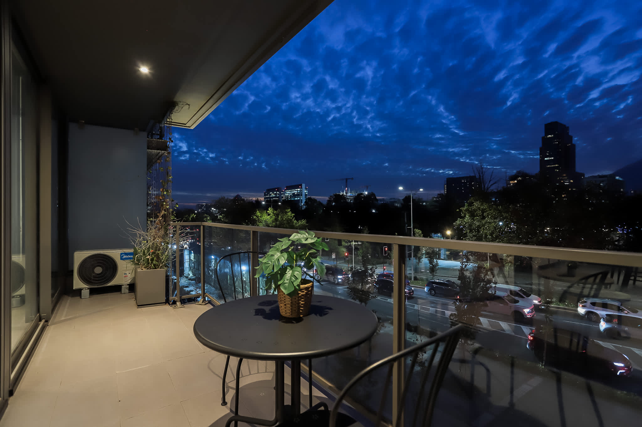 Experience breathtaking city views from this charming patio, perfect for evening relaxation or a romantic dinner under the stars.