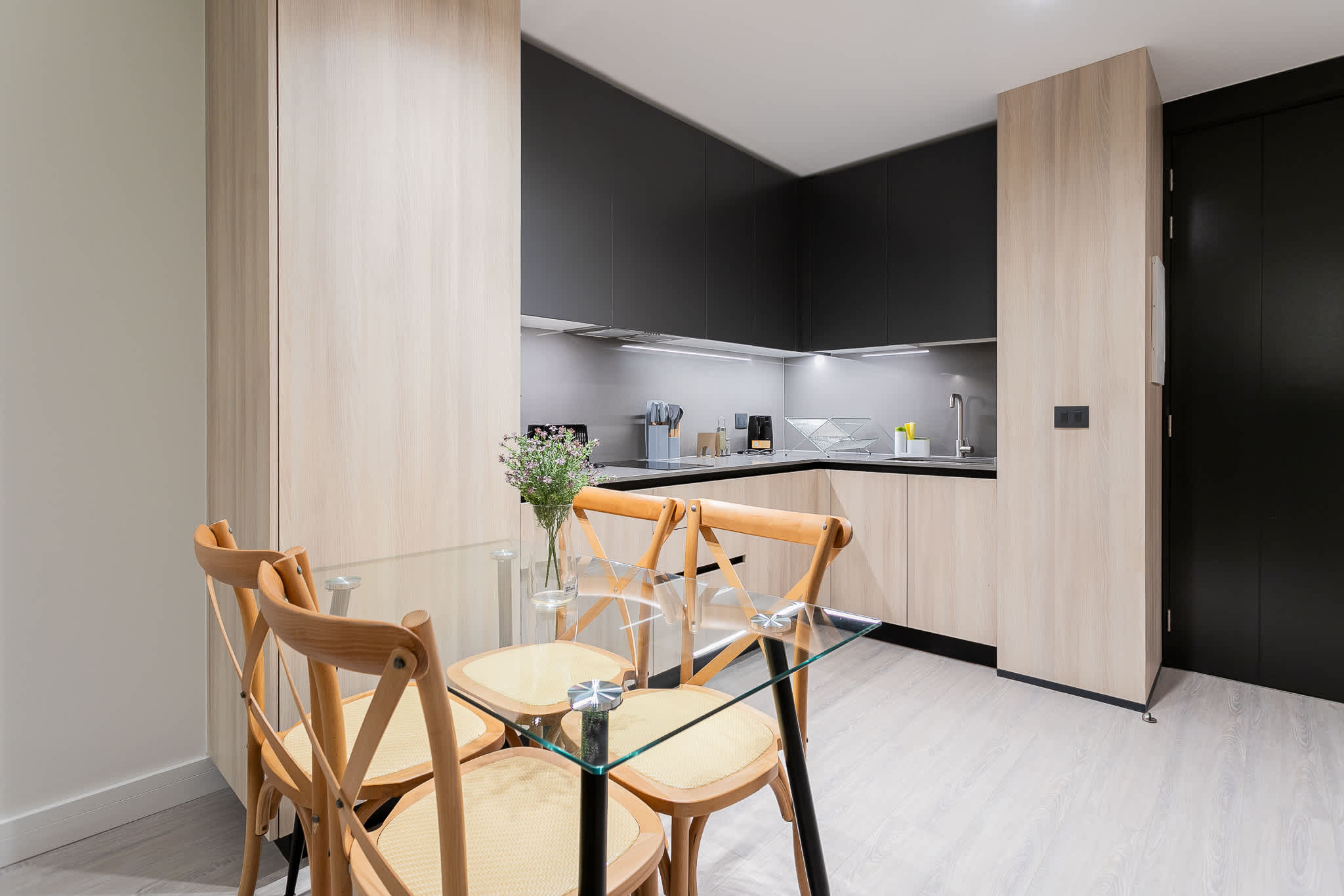 Sleek and modern kitchen with elegant dining area, perfect for cozy meals and culinary adventures.