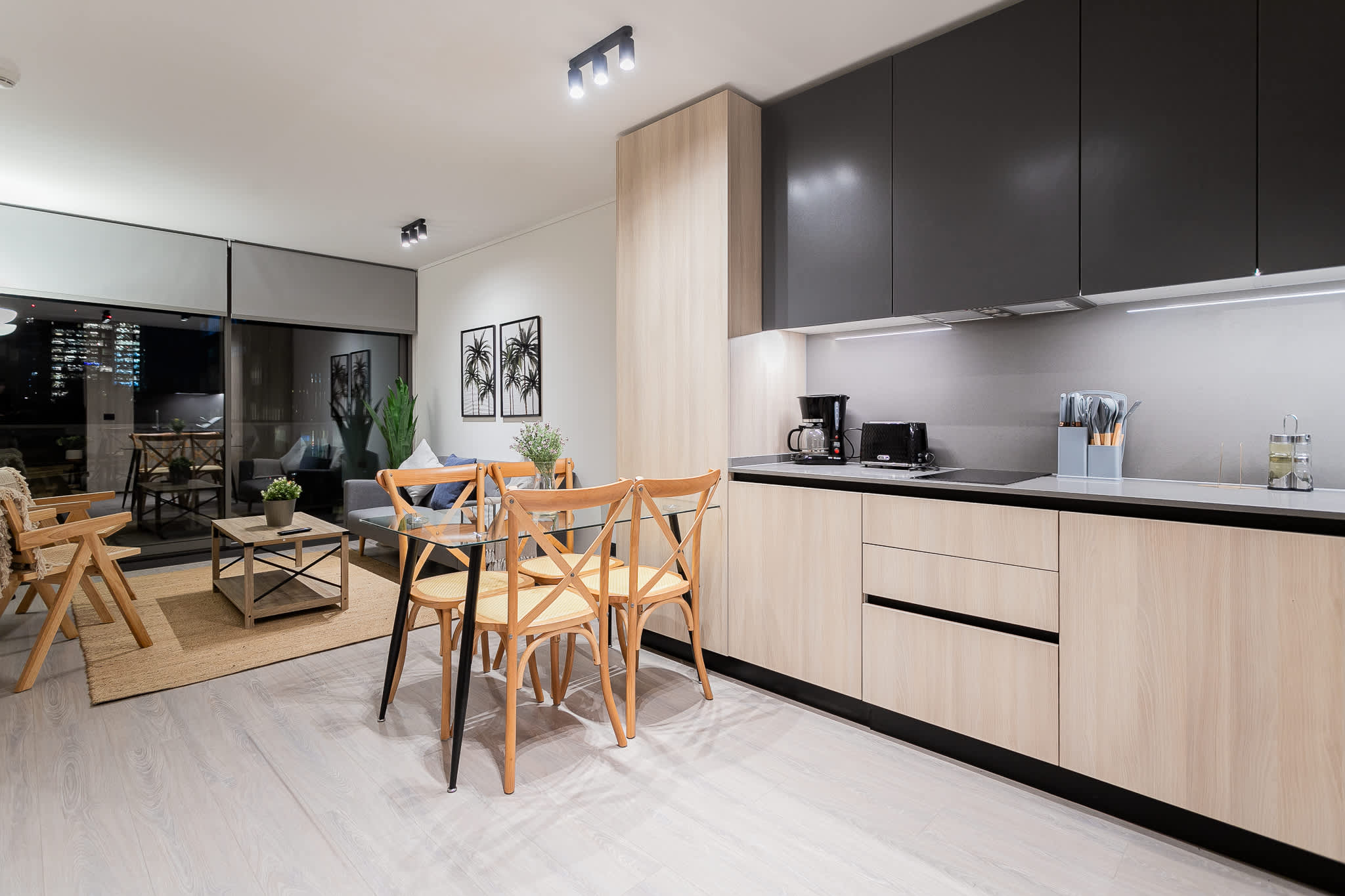 Experience modern living with this stylish open-plan space, featuring a sleek kitchen and cozy seating area with stunning city views.