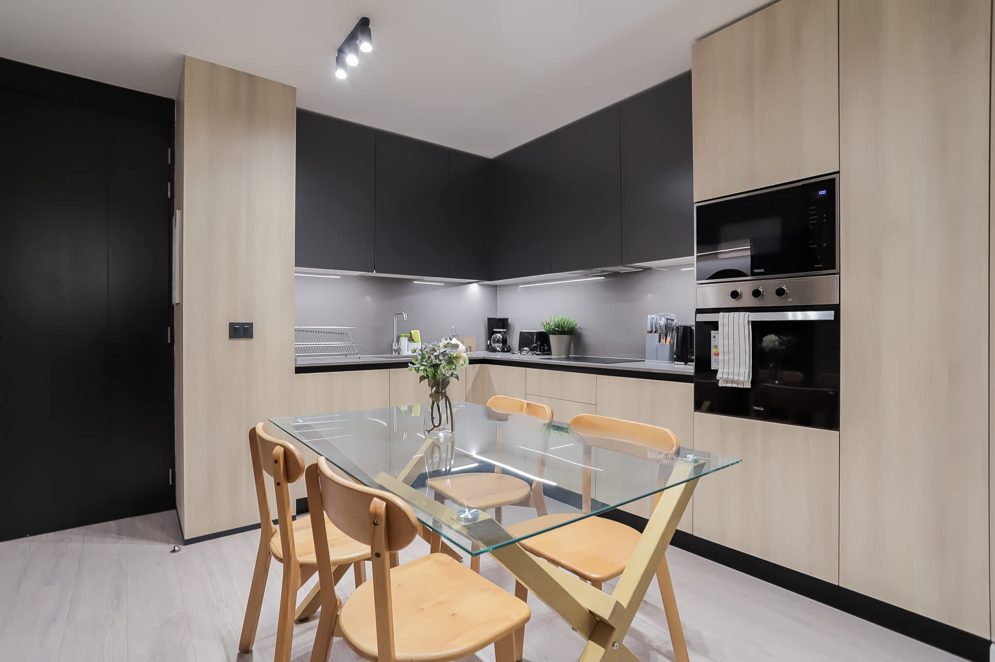 Experience culinary delight in this sleek, modern kitchen with elegant finishes and a stylish dining area.