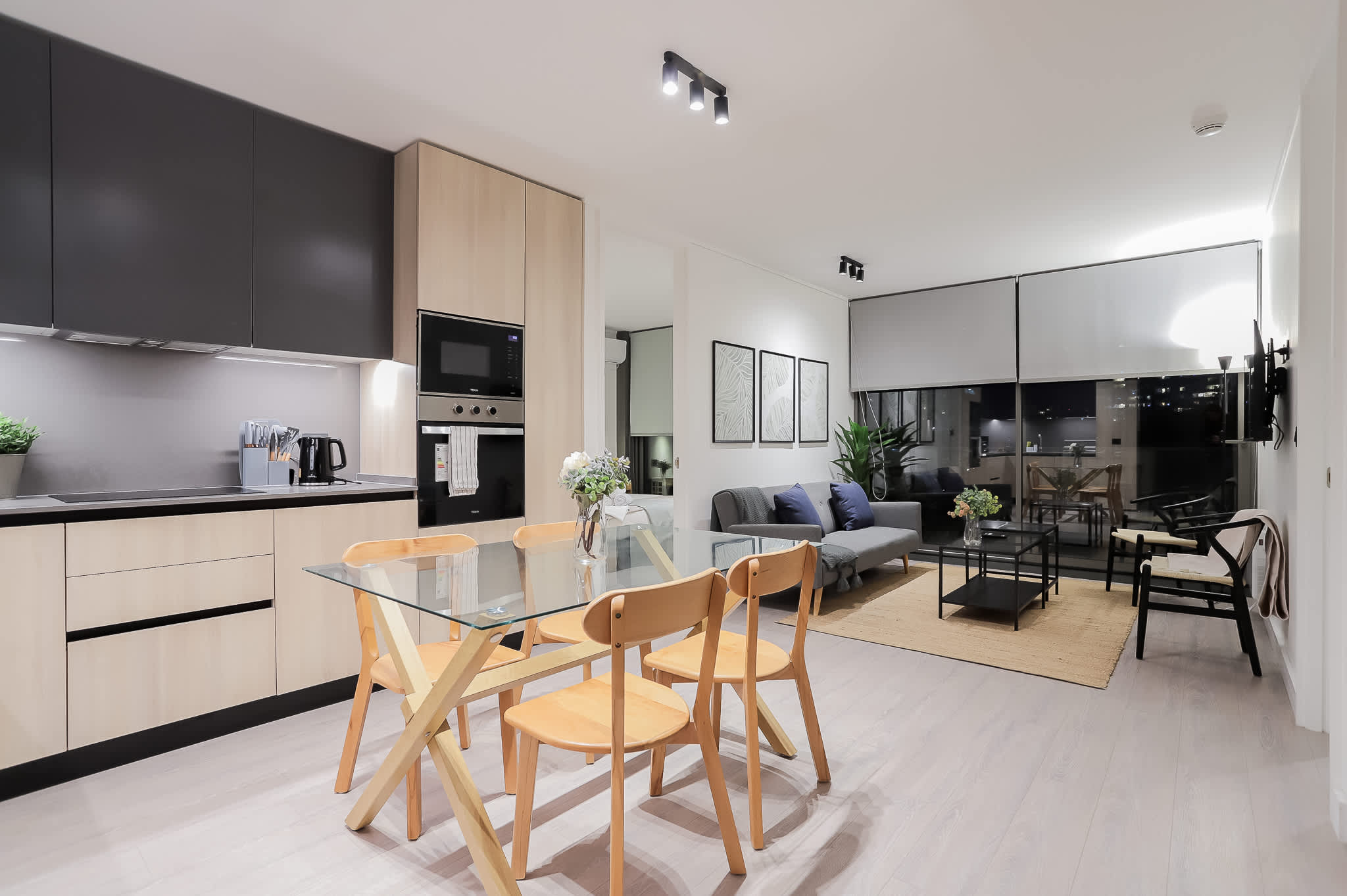Experience modern living in this stylish open-plan space, perfect for dining and relaxation with city views through expansive windows.