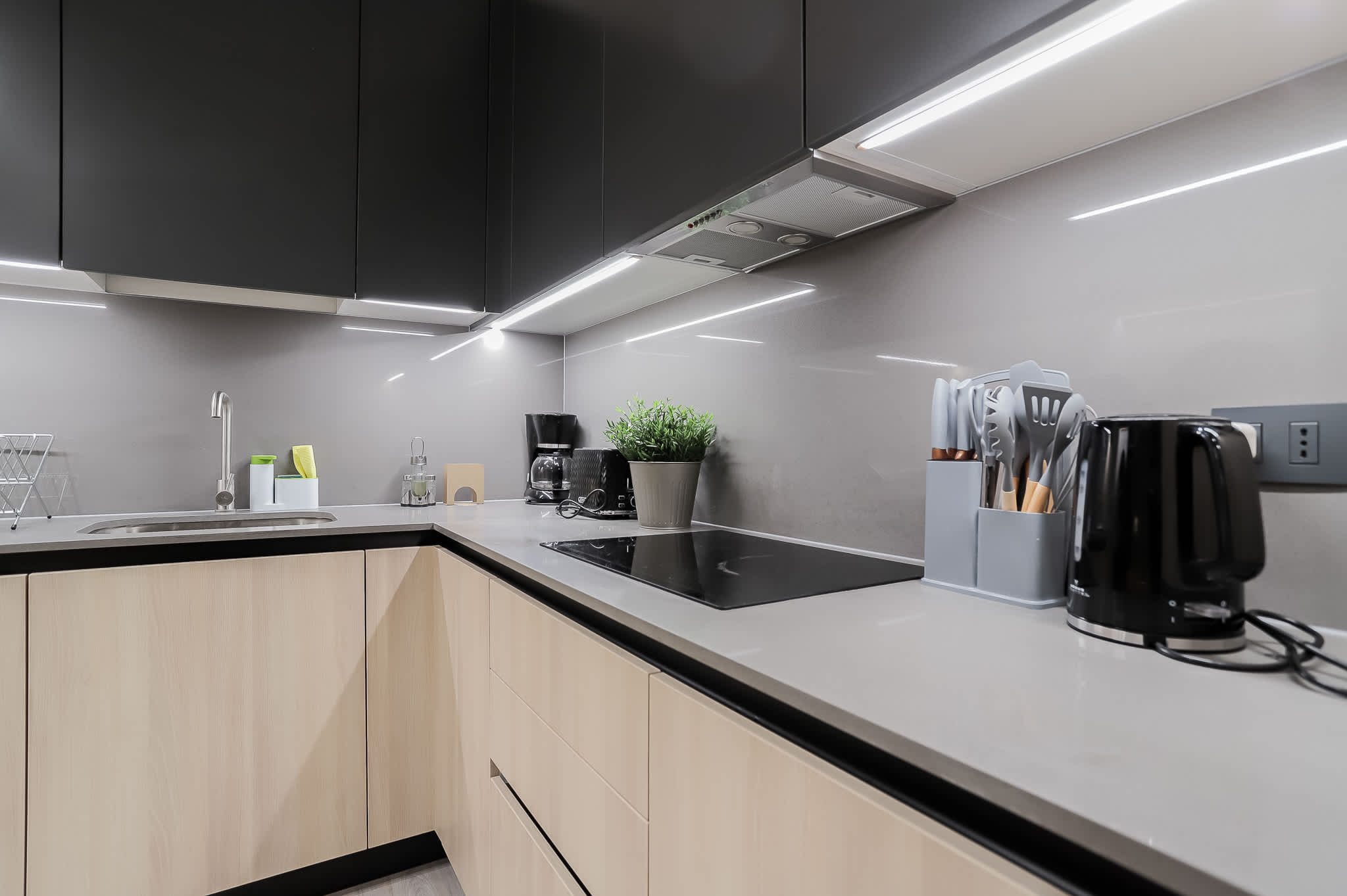 Sleek and modern kitchen with top-notch appliances and stylish lighting, perfect for culinary adventures.