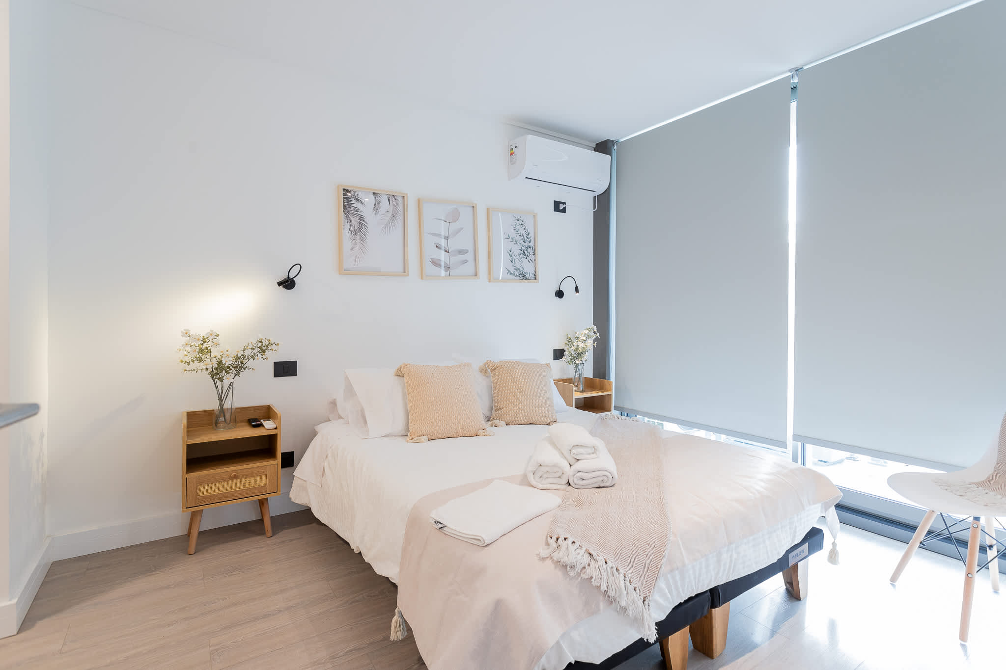 Experience tranquility in this modern bedroom, featuring a cozy queen bed, stylish decor, and abundant natural light for a restful retreat.