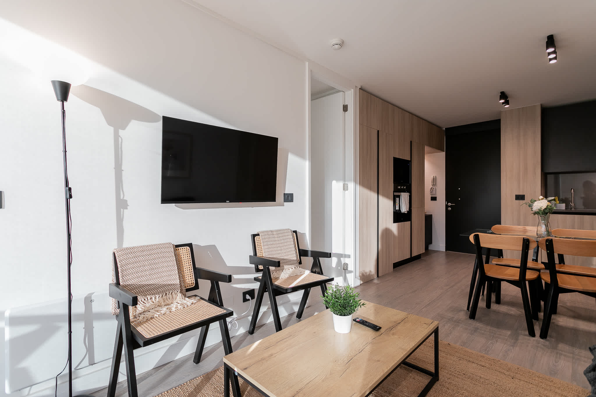 Experience modern comfort in this stylish living space, perfect for relaxation and dining in a chic, minimalist setting.