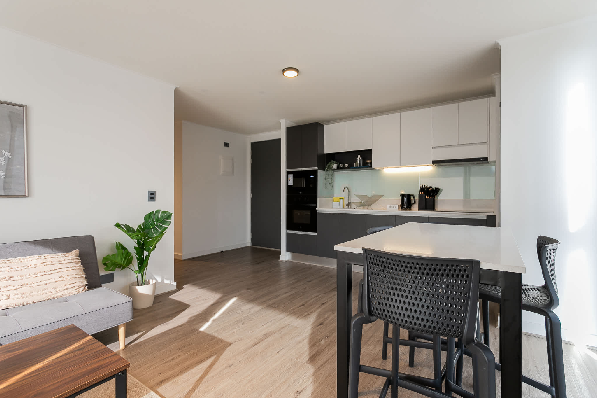 Experience modern comfort in this stylish kitchen with a cozy seating area, perfect for relaxing after a day of exploring.