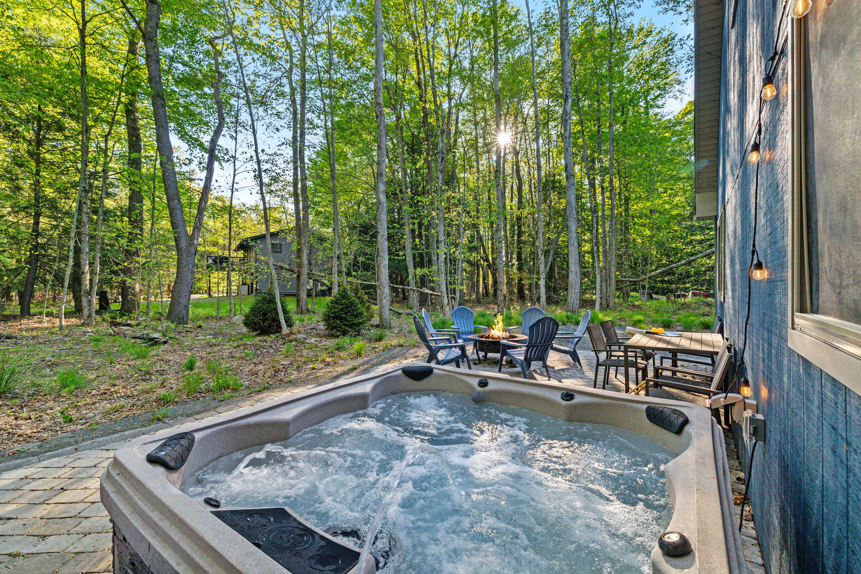 Soak in the outdoor hot tub on the private patio, with serene forest views all around. A perfect spot to unwind and take in nature’s beauty.
