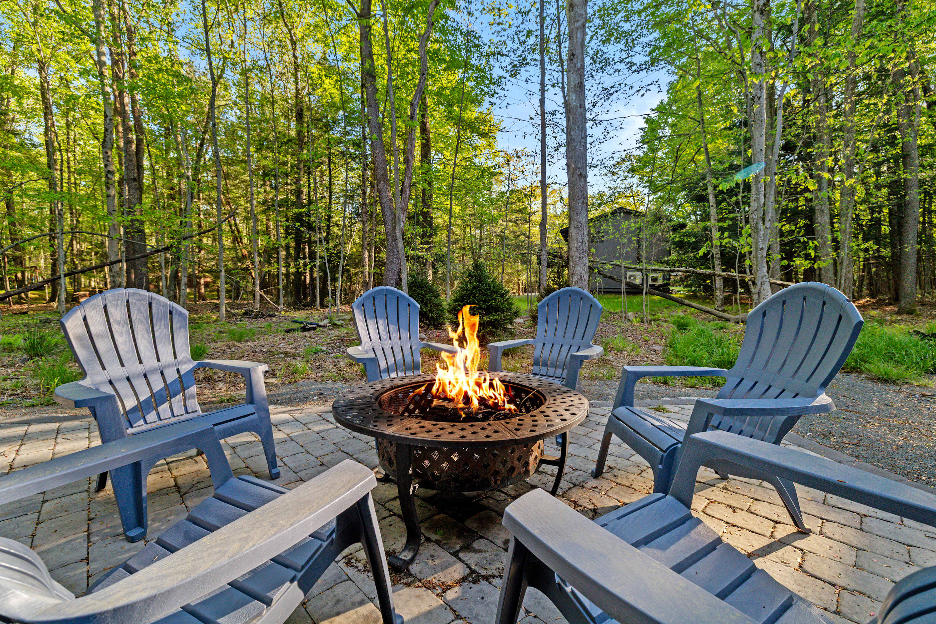 Gather around the outdoor wood-burning fire pit, surrounded by nature. A great spot for an evening of warmth, laughter, and making memories with friends or family.