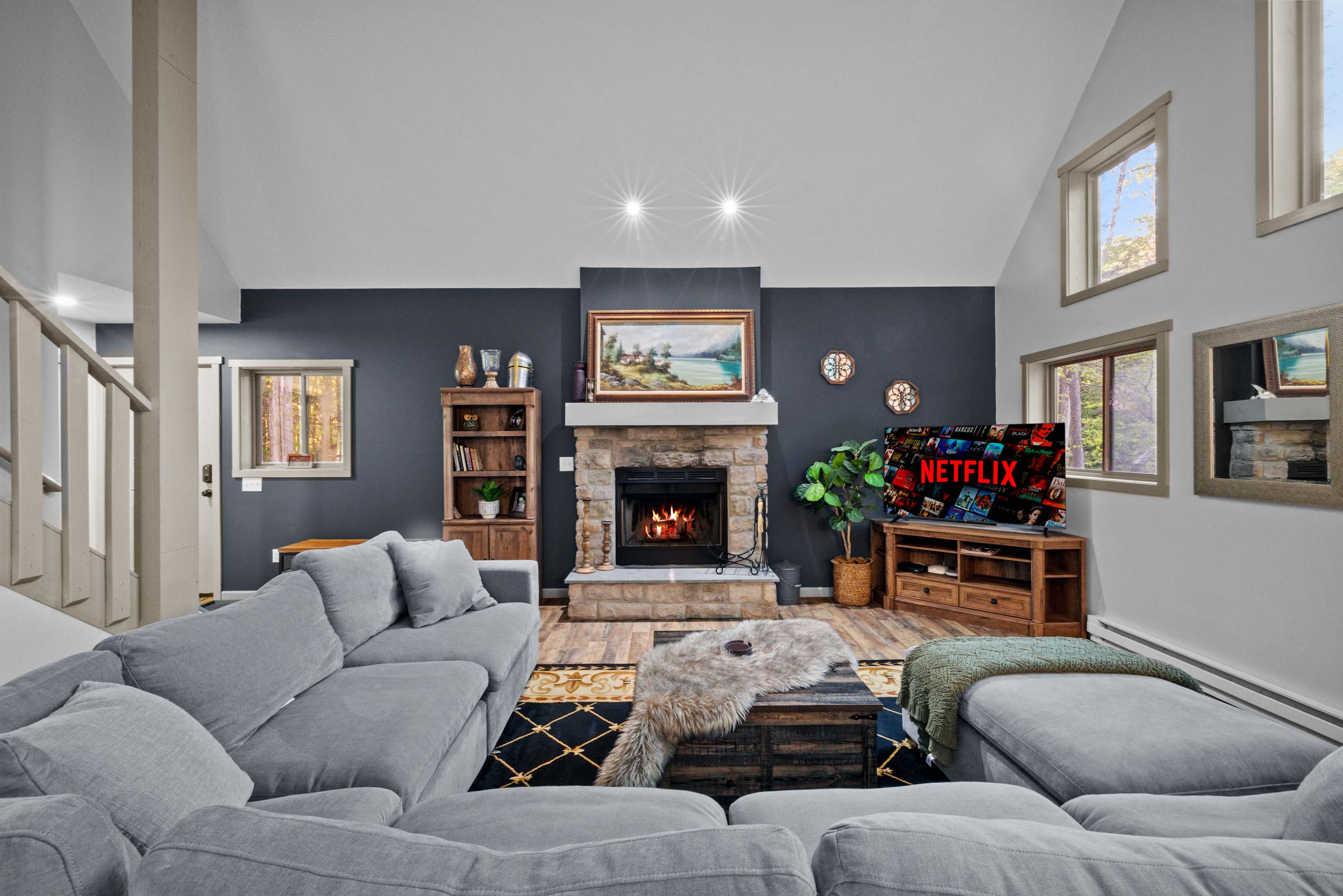 Relax by the warmth of the wood-burning fireplace, unwind on the spacious couch, and enjoy your favorite show on the large TV. Perfect for a cozy night in.