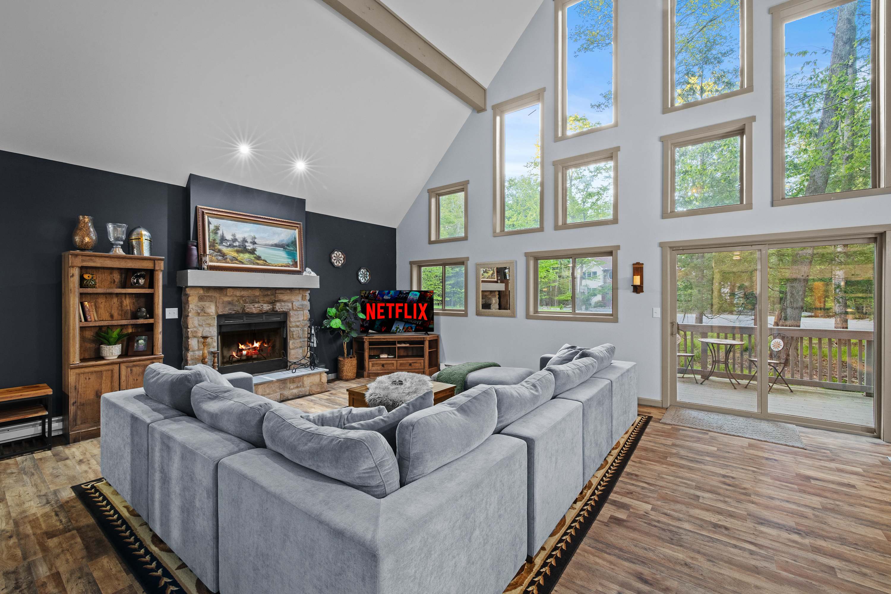 Catch up on your favorite shows on the large sectional sofa with natural light filtering in.