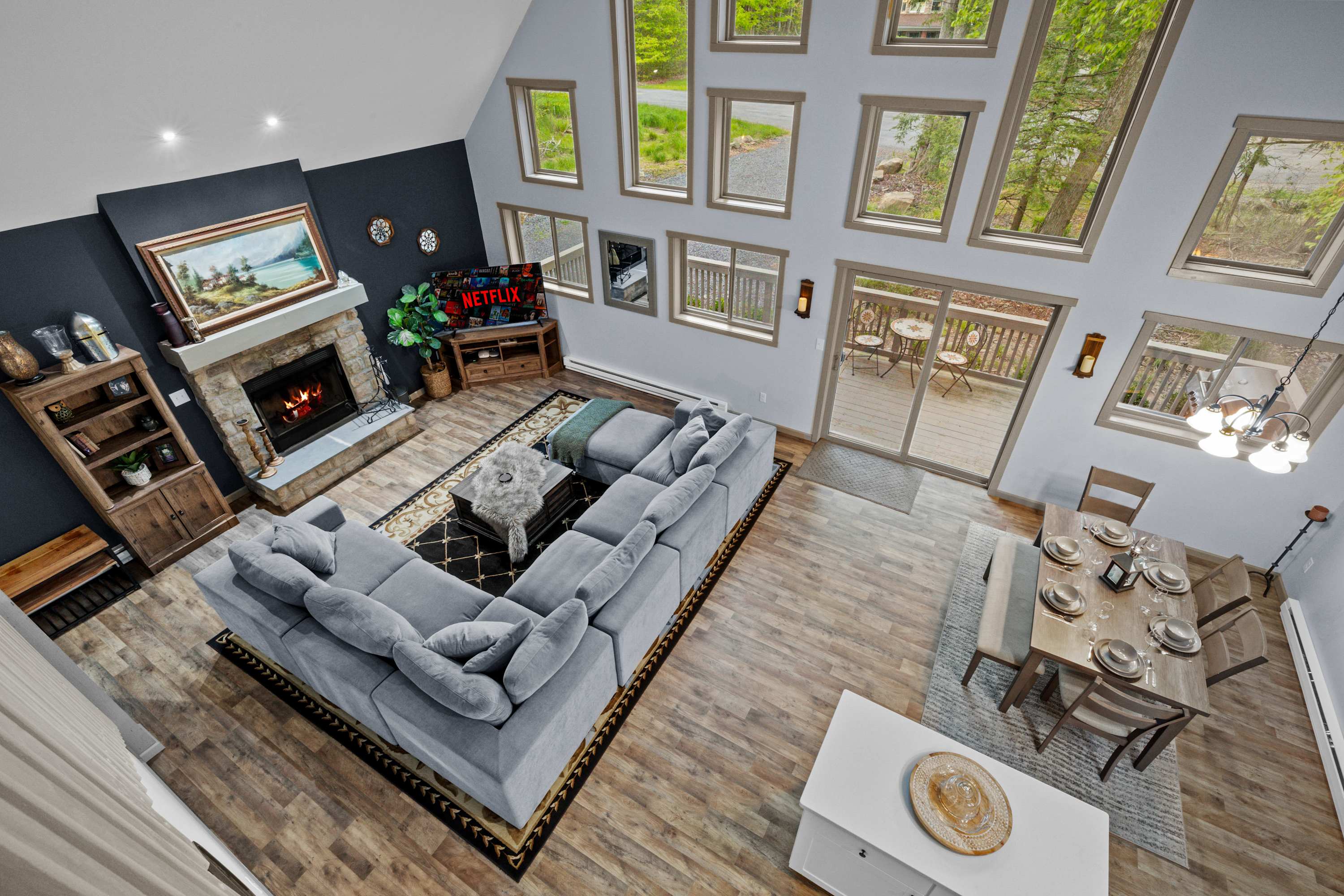 Spacious great room featuring a large sectional sofa, perfect for both relaxation and entertaining. High ceilings and plenty of natural light make this space bright and inviting.