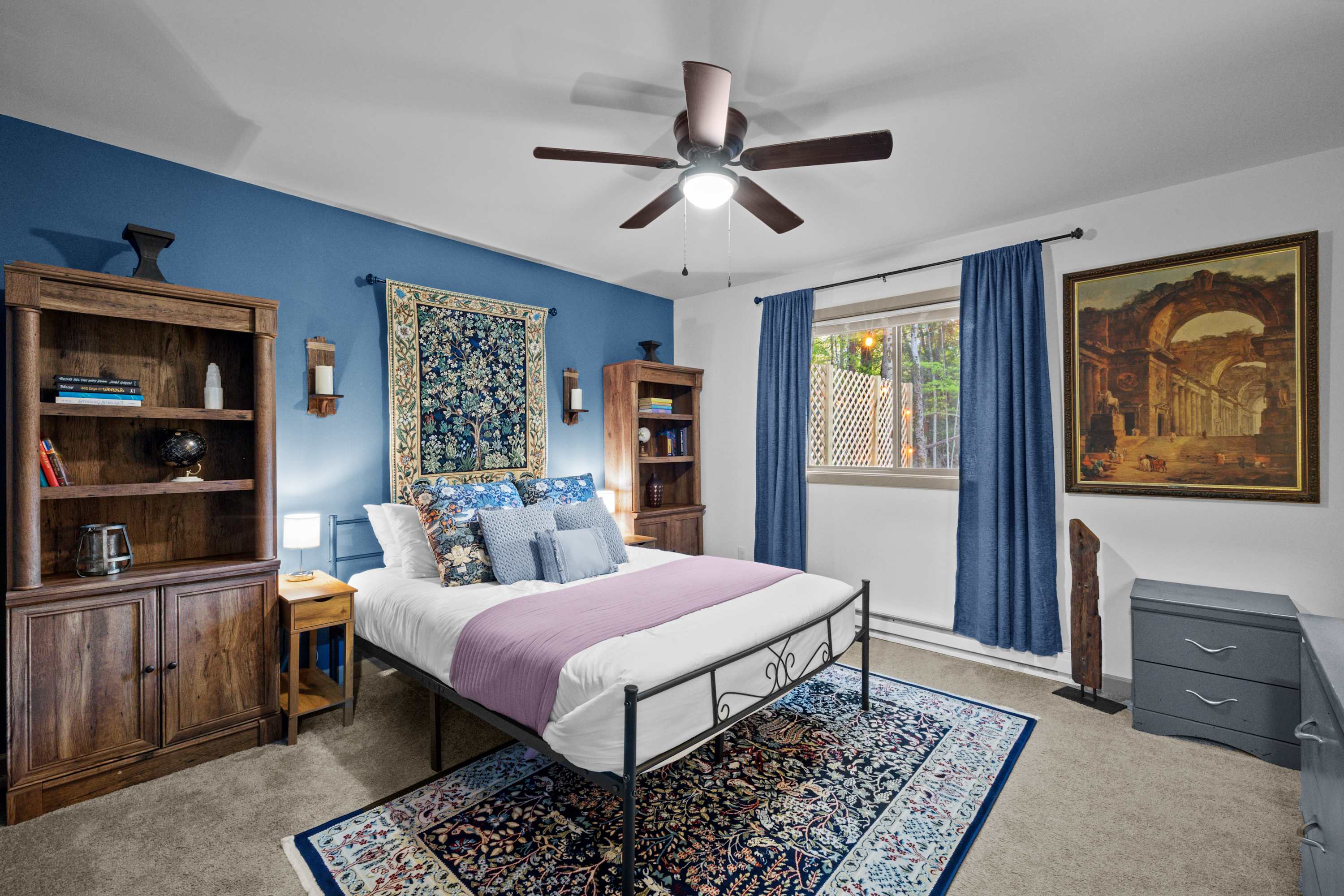 Enjoy a restful night's sleep with a queen bed, room darkening shades, and a ceiling fan for added comfort.