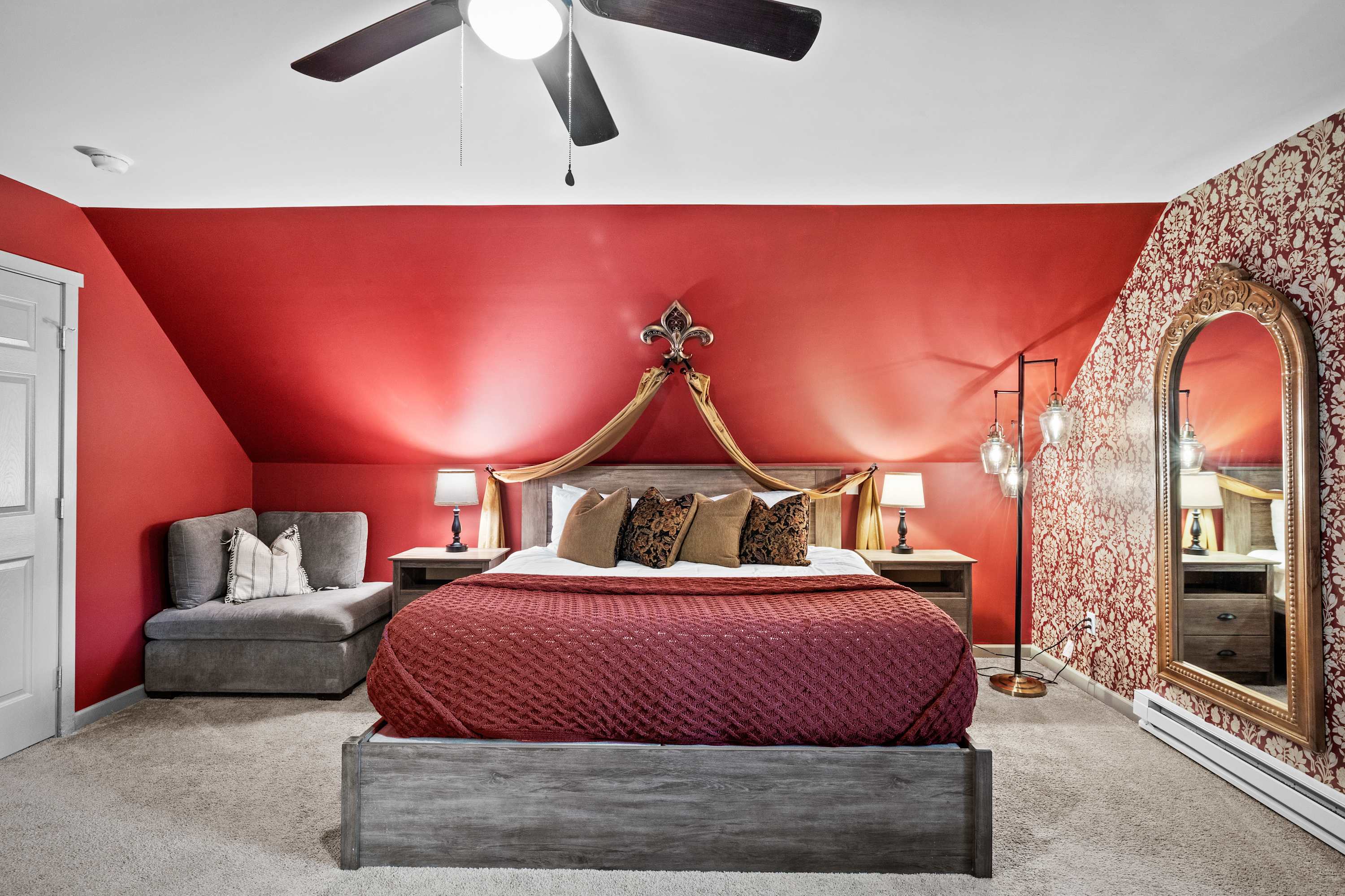 Master bedroom with a king bed and a relaxing corner seating area—your ideal retreat for comfort and rest.