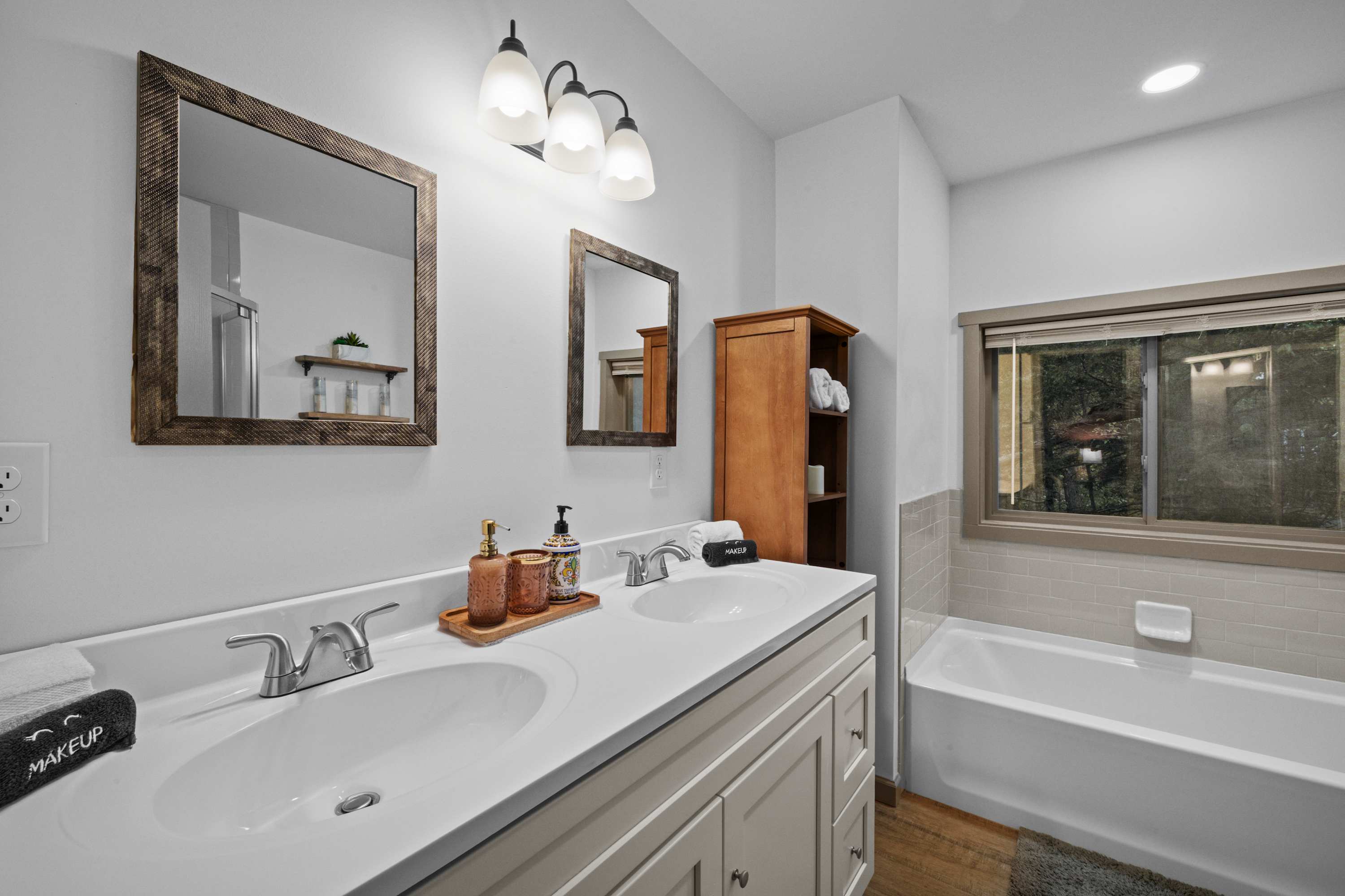 Master bathroom: His and hers space with a clean, modern design, complete with a soaking tub and stocked with all the essentials for your convenience.