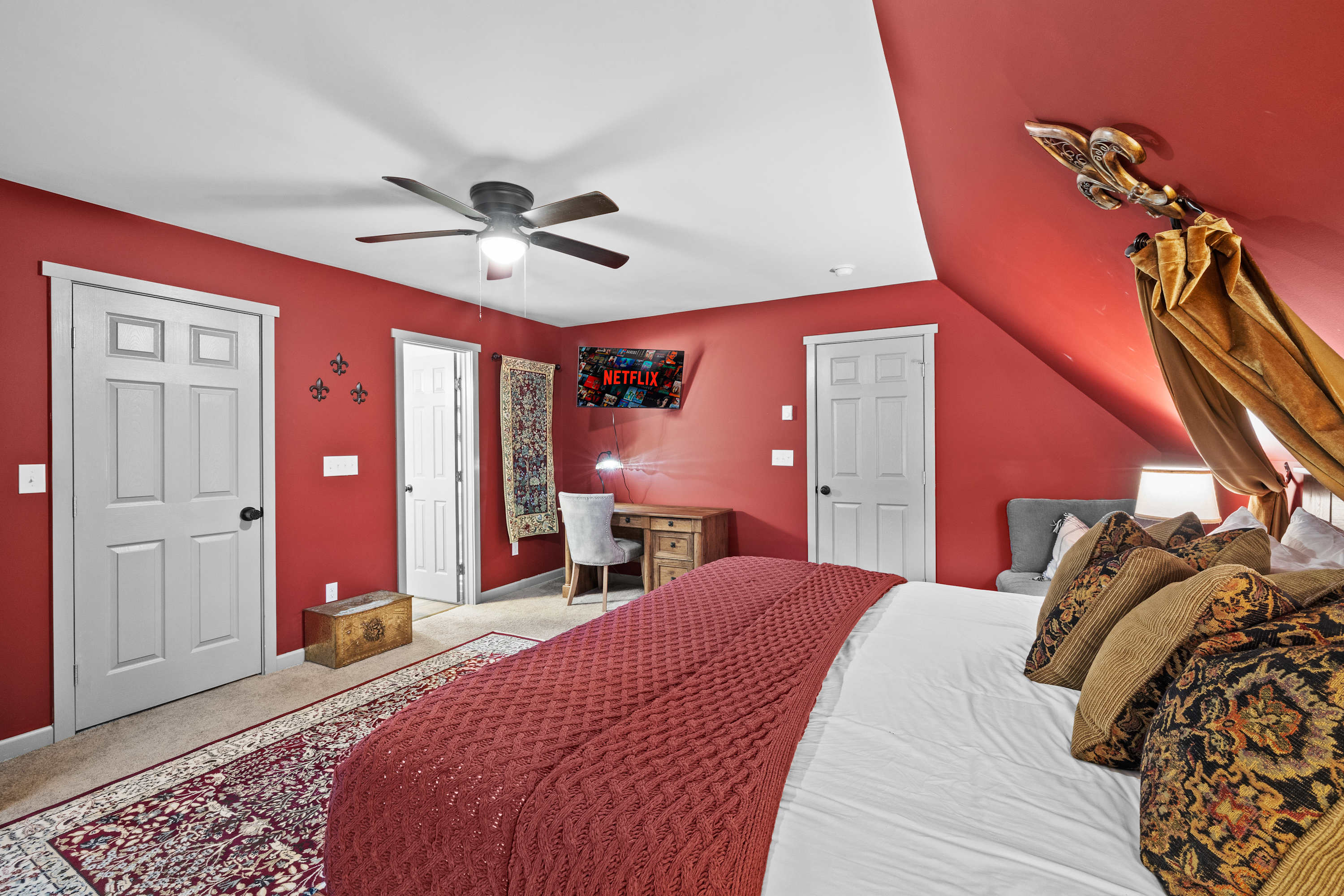 Master bedroom with a comfy king bed, TV, work desk, wardrobe for clothing storage, and a ceiling fan for a breezy night’s sleep!