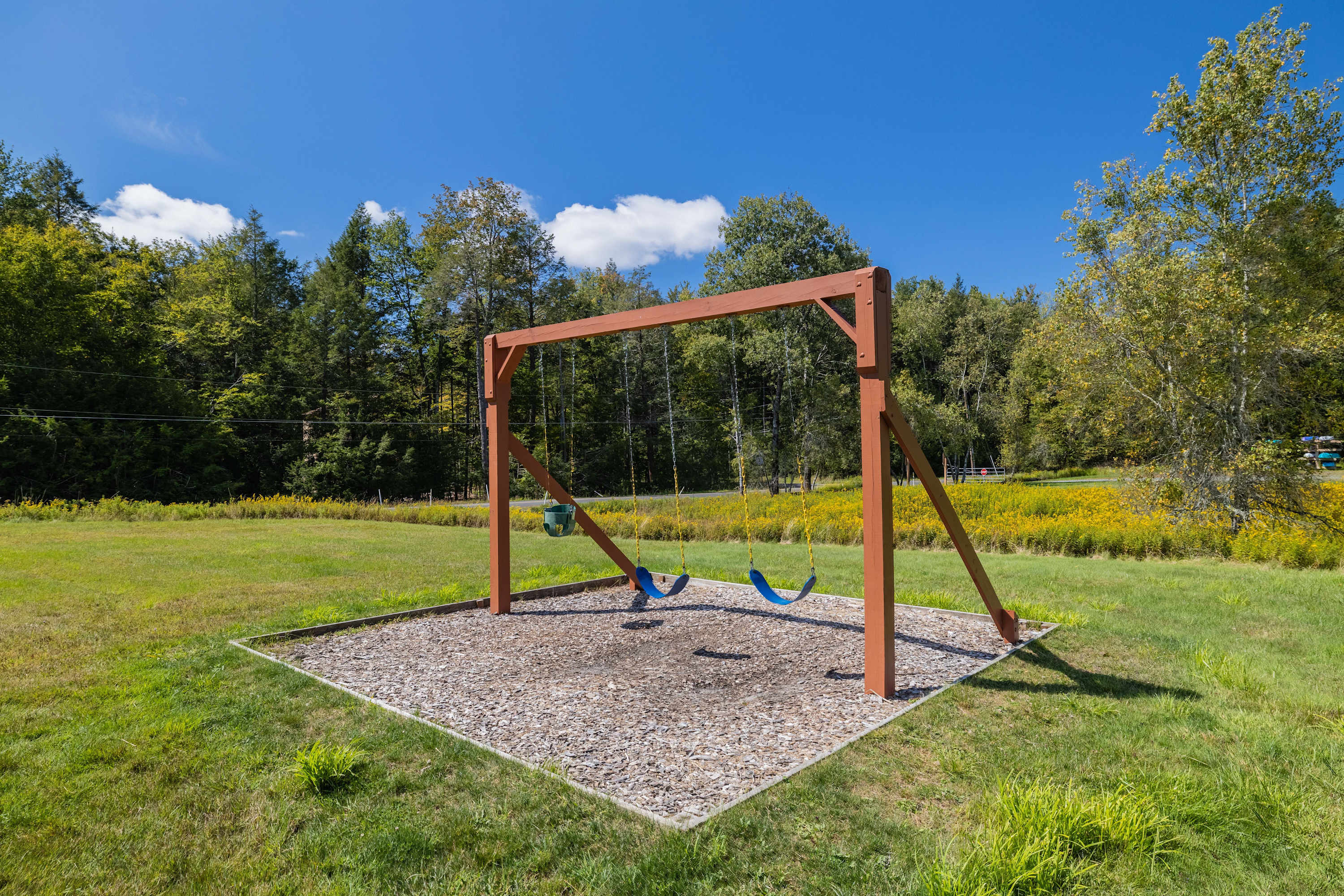 A swingset for your little ones to enjoy near the beach
