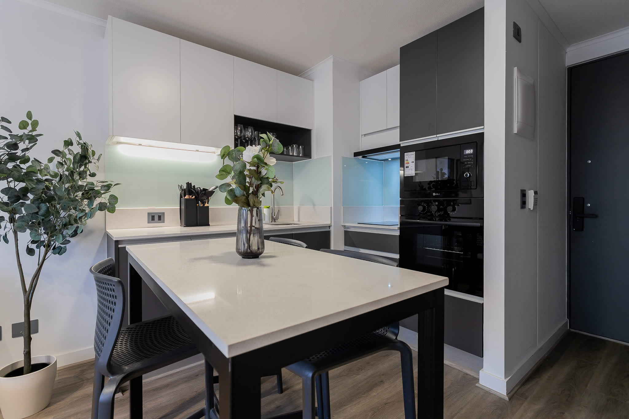 Sleek and modern kitchen with dining space, perfect for enjoying meals in style.