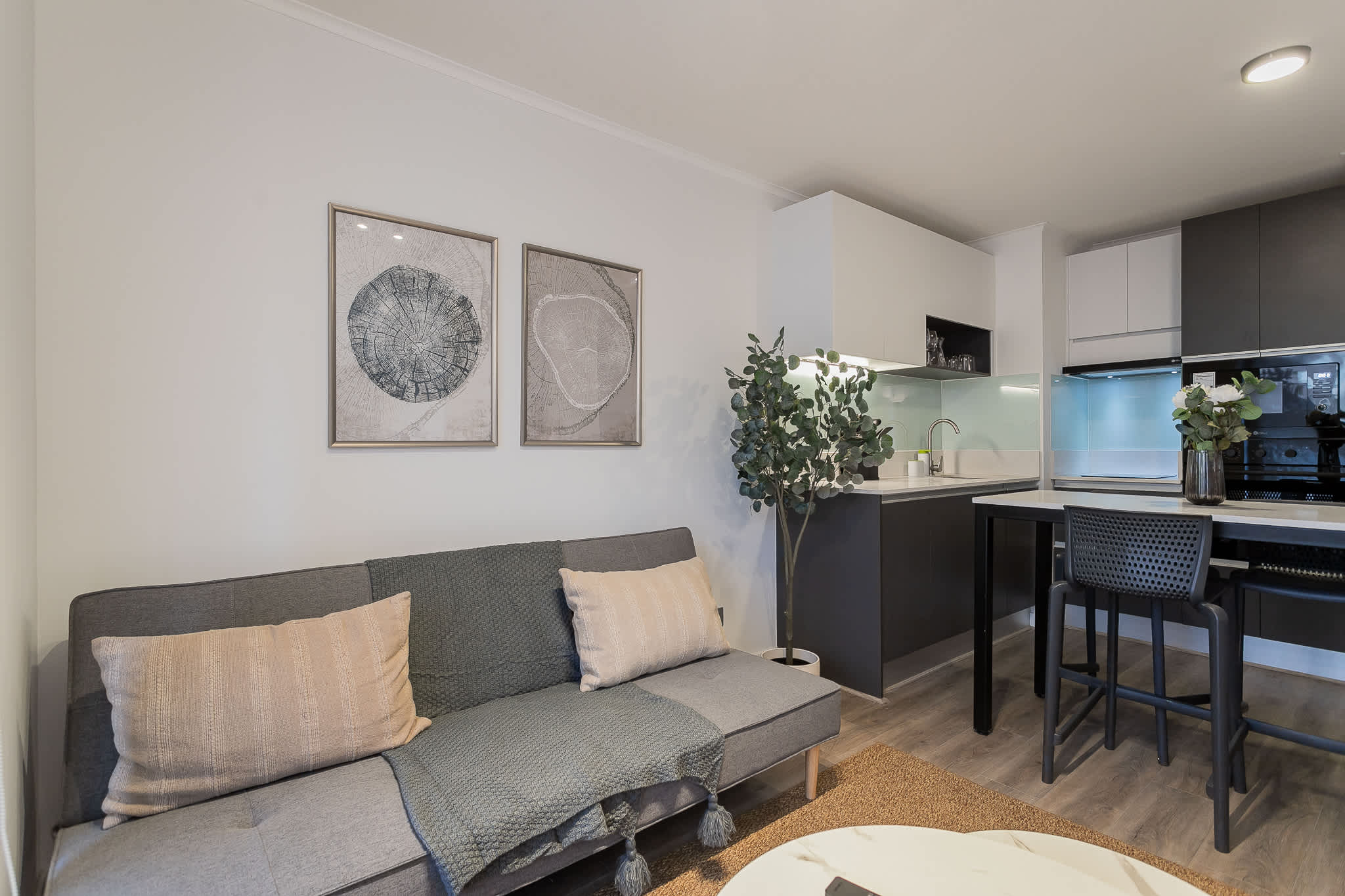 Cozy and modern living area with sleek kitchen and stylish decor, perfect for a relaxing stay.