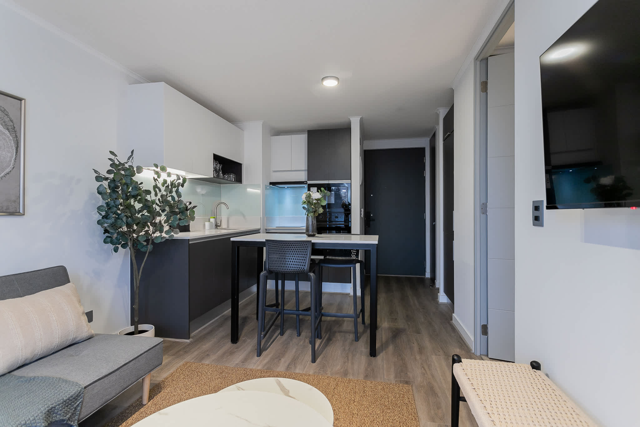 Chic and modern studio kitchen with cozy seating, perfect for a relaxing stay in the heart of Chile.