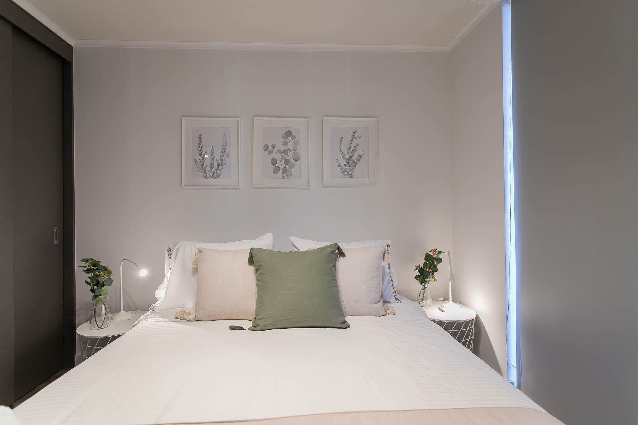 Relax in this serene bedroom with stylish decor and cozy bedding, perfect for unwinding after a day of exploring.