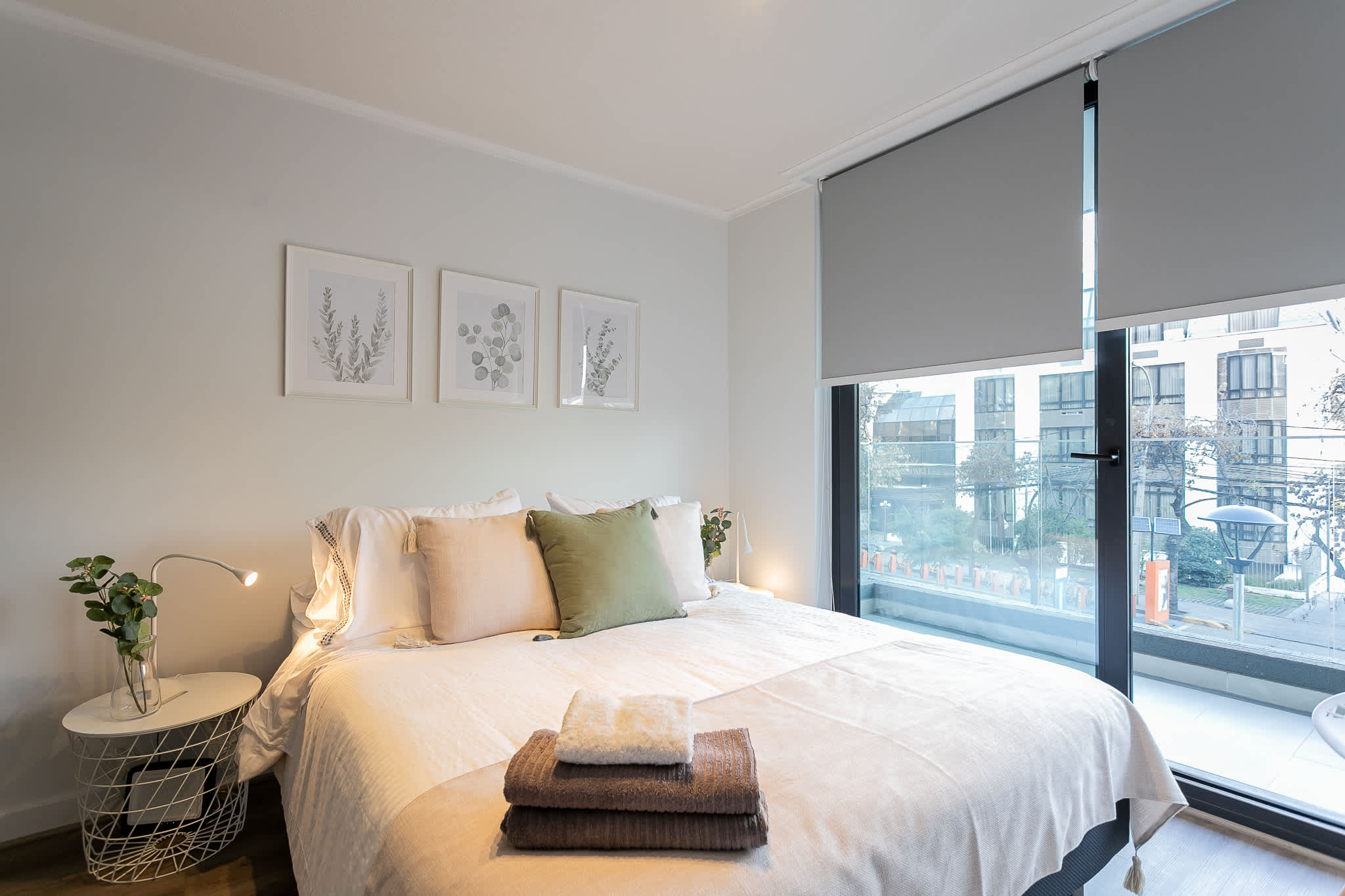 Relax in this cozy bedroom with a comfy bed and a view, perfect for unwinding after exploring the city.