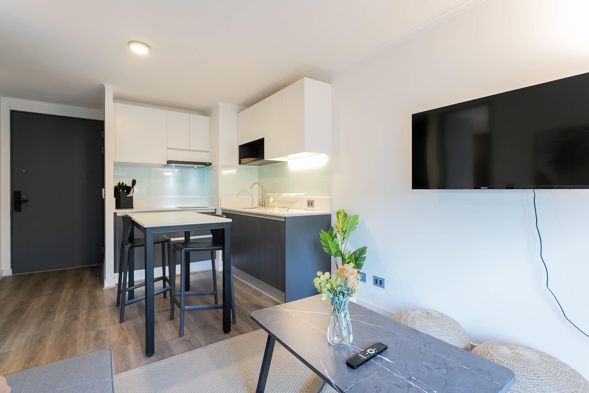 Chic and modern kitchen with dining area, perfect for cozy meals and relaxation.