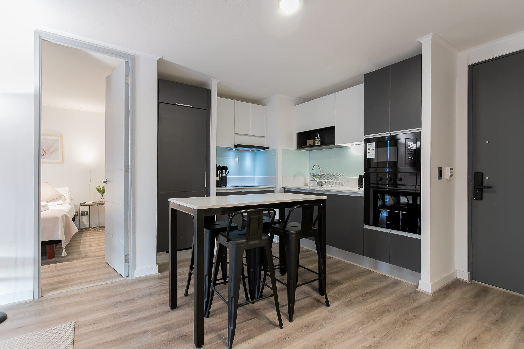 Experience modern living in this sleek kitchen with high-top dining, perfect for intimate meals or casual gatherings.