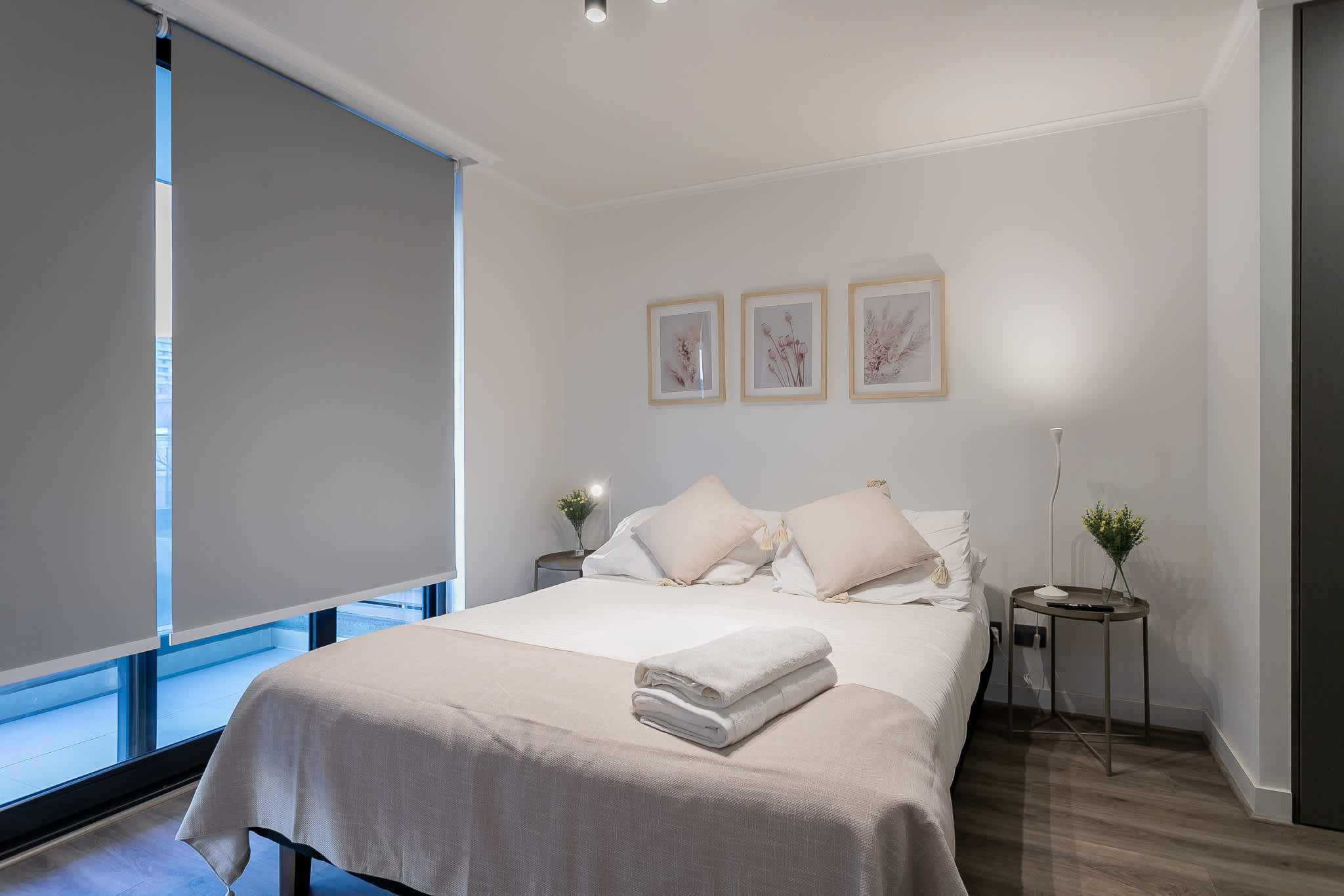 Relax in this serene bedroom with soft lighting and elegant decor, perfect for a restful night's sleep.