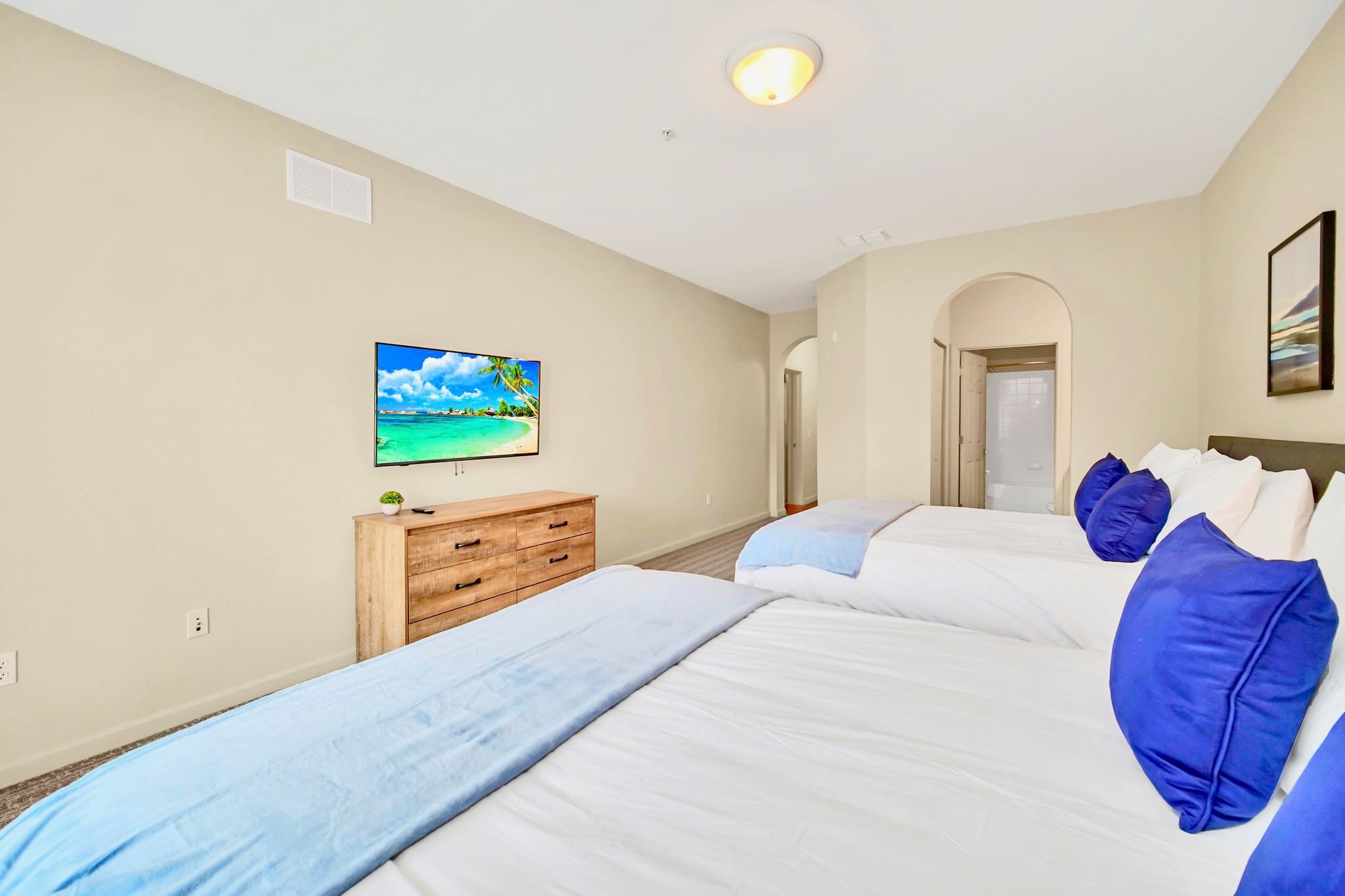 Twin queen bedroom with en-suite bathroom and smart TV