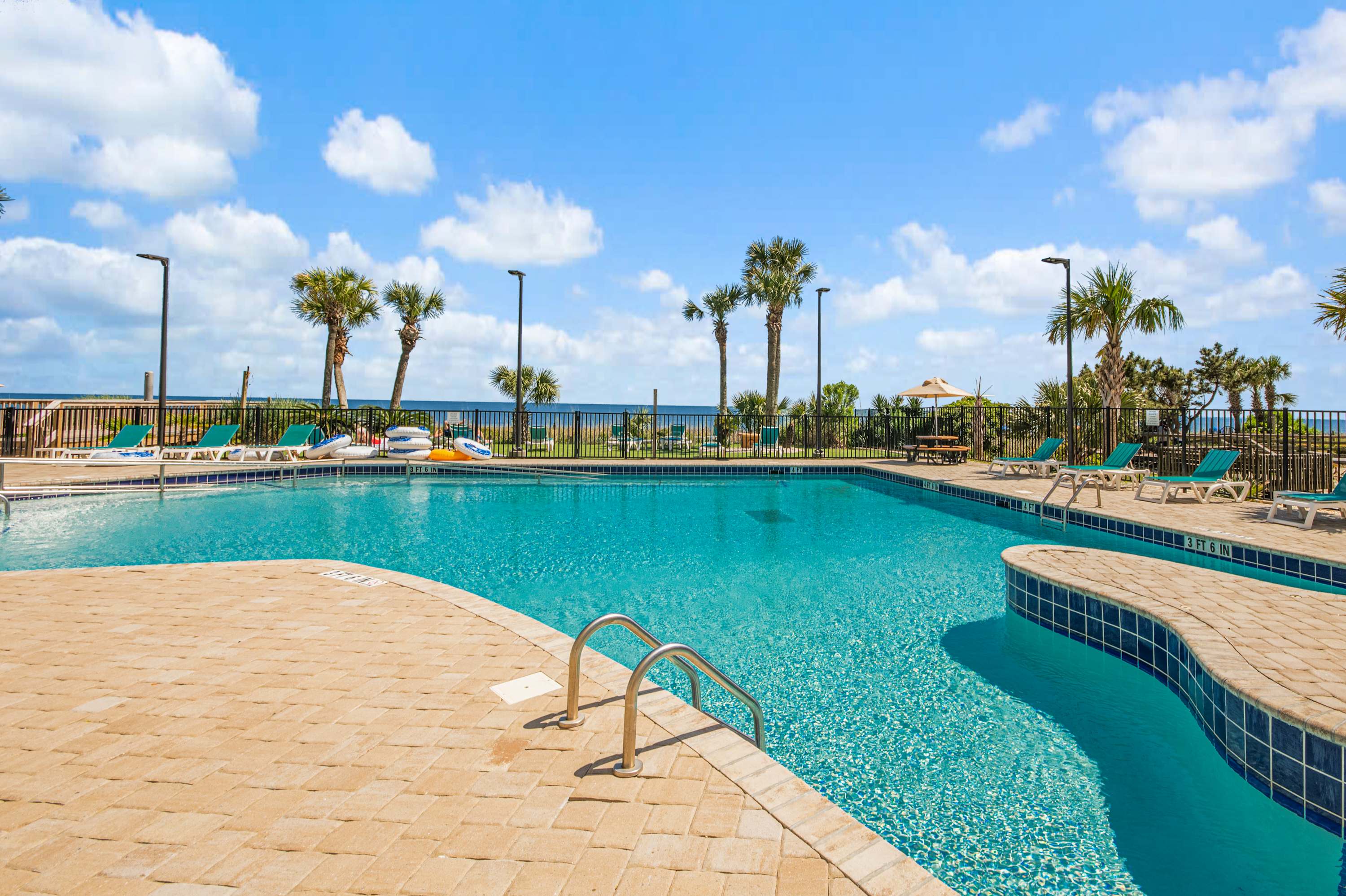 Dive into vacation mode in the sparkling outdoor pool—just steps from your door.
