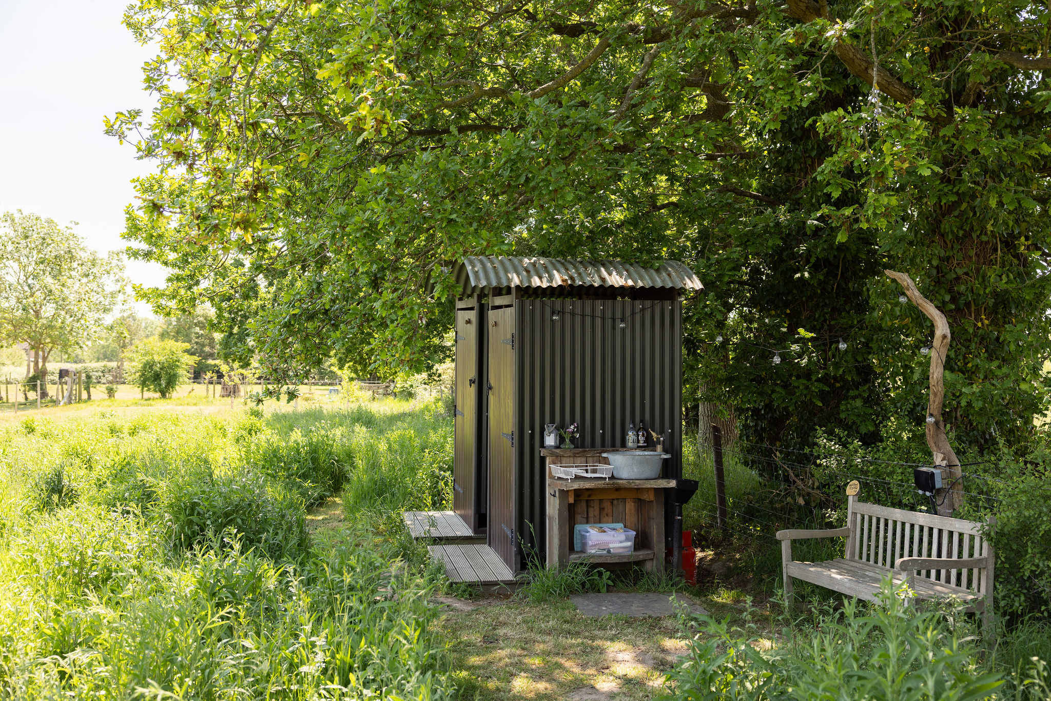 The shower and the toilet are just by the hut