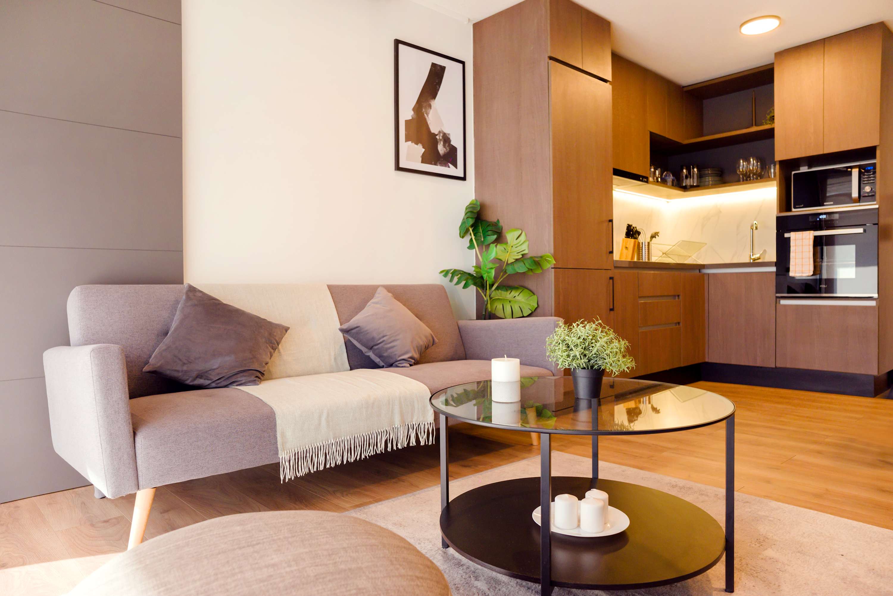 Cozy modern living area with sleek kitchen and stylish decor, perfect for a relaxing stay.