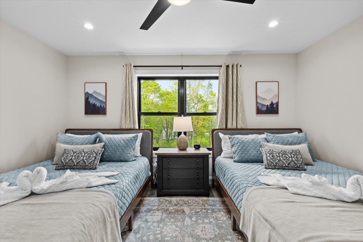 Cool teal walls create a calming atmosphere in this comfortable bedroom with plush bedding.