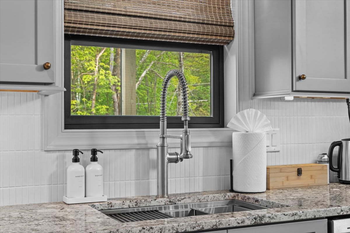 Natural light streams in through the window above the kitchen sink.