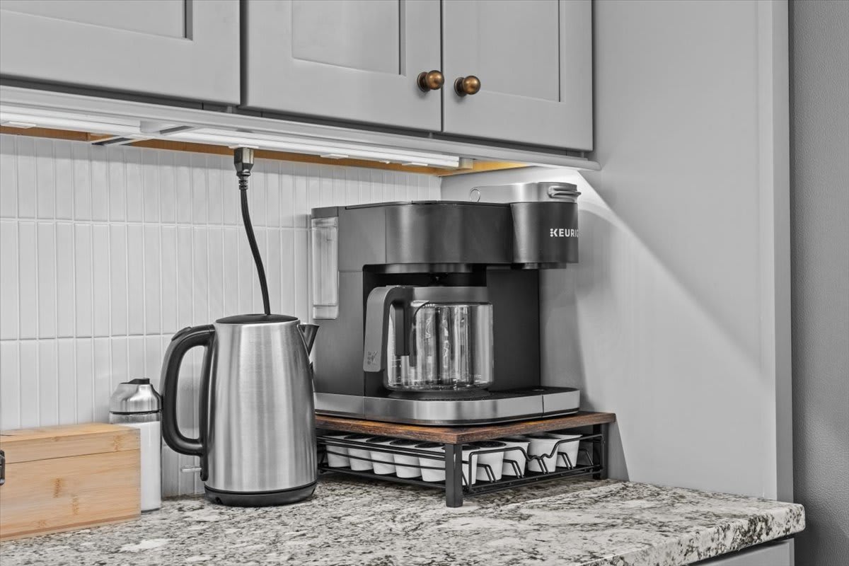 Start your morning with the coffee station featuring a Keurig and kettle.